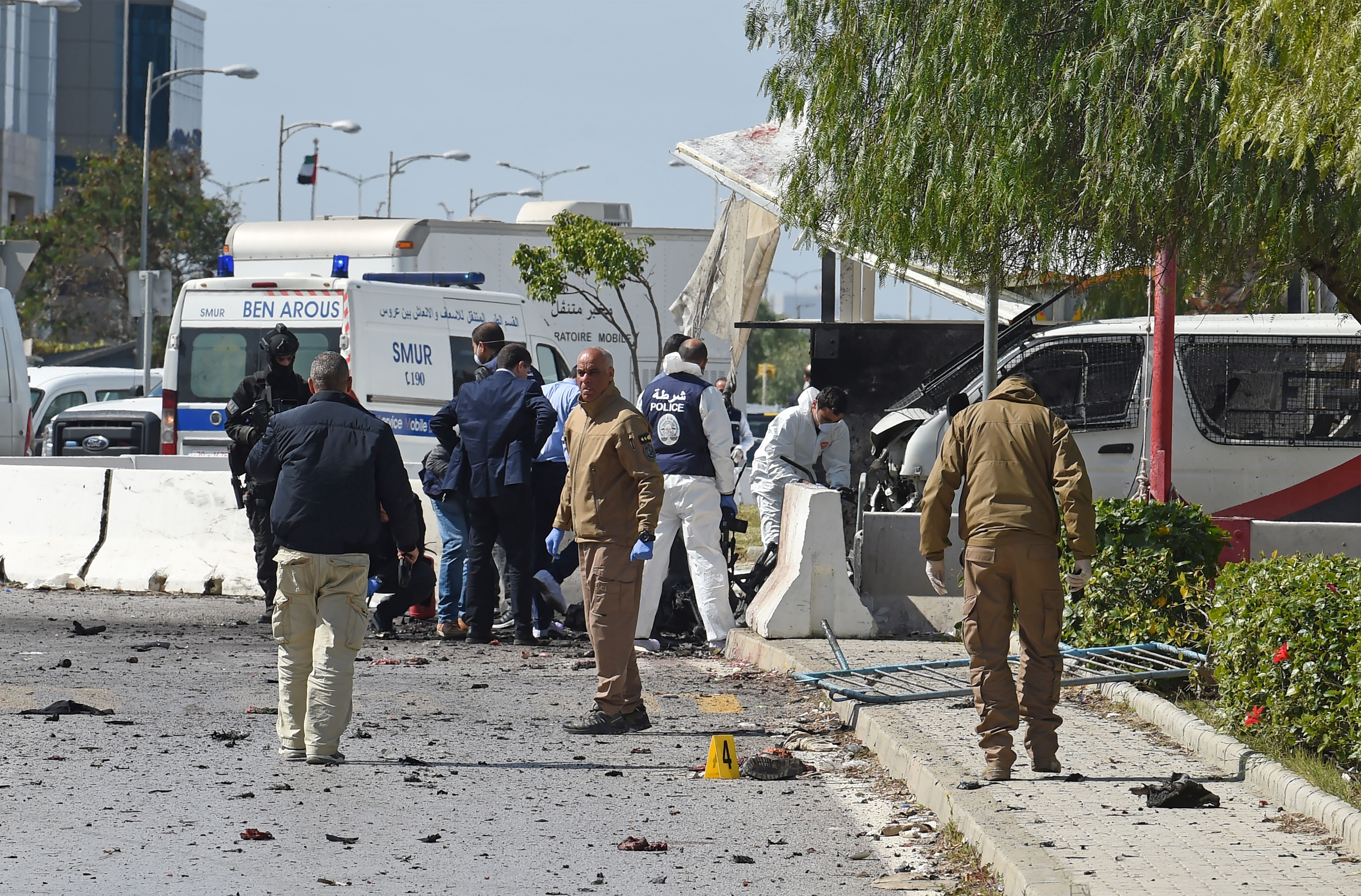 Police and forensic experts inspect the scene of an explosion near the US embassy in the Tunisian capital Tunis (Photo by FETHI BELAID/AFP via Getty Images)