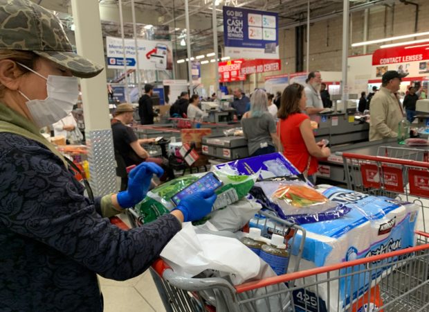 Customers wait in line to buy water and other supplies, on fears that the coronavirus, COVID-19, will spread and force people to stay indoors, at a Costco in Burbank, California on March 6, 2020. - US lawmakers passed an emergency USD 8.3 billion spending bill to combat the coronavirus on Thursday as the number of cases surged in the country's northwest and deaths reached 12. Since then the toll has risen to 12 and the virus has spread to at least 15 states -- the latest being Maryland adjacent to the nation's capital Washington. (Photo by Robyn BECK / AFP) (Photo by ROBYN BECK/AFP via Getty Images)
