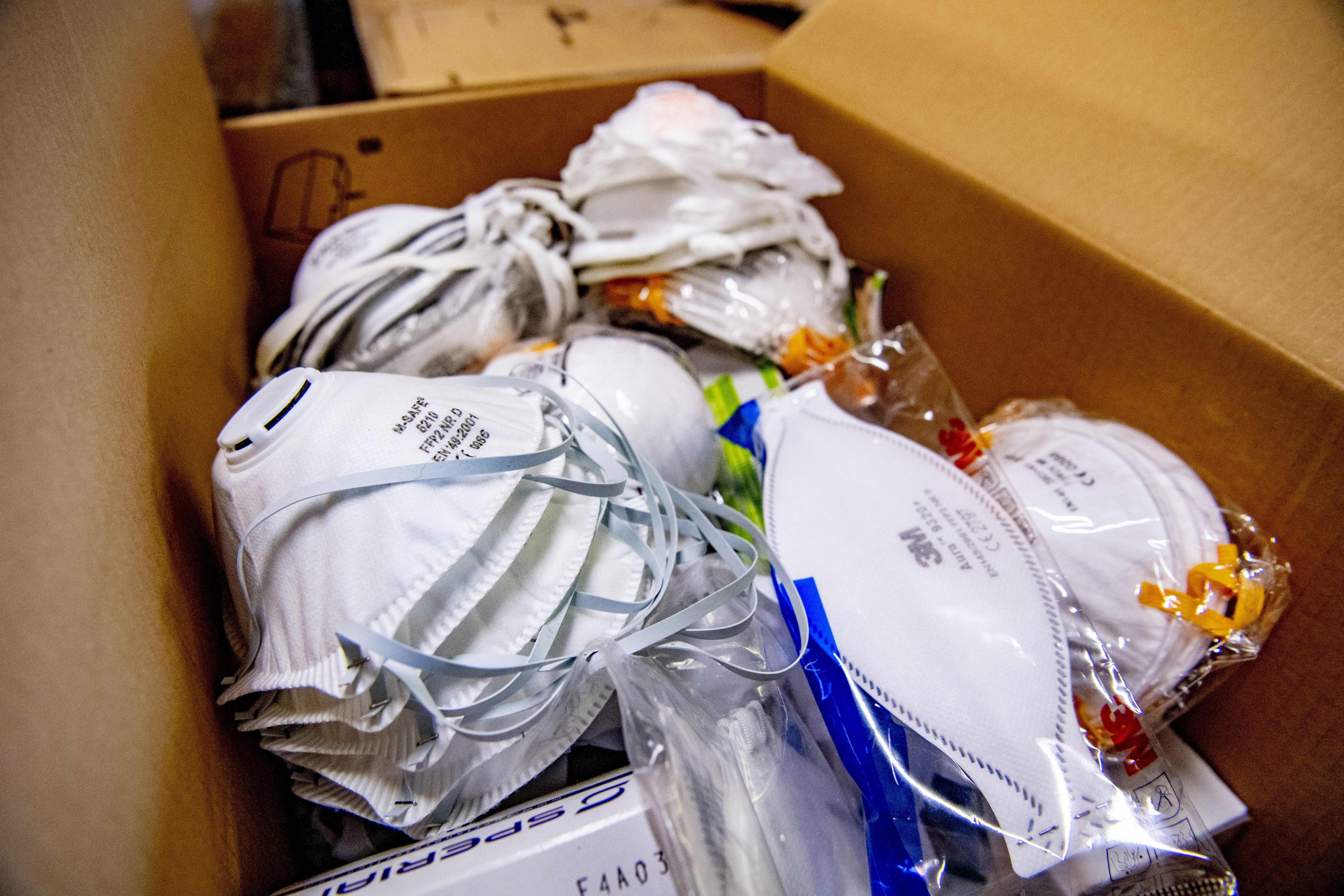 Protective face masks are pictured in a box (Photo by ROBIN UTRECHT/ANP/AFP via Getty Images)
