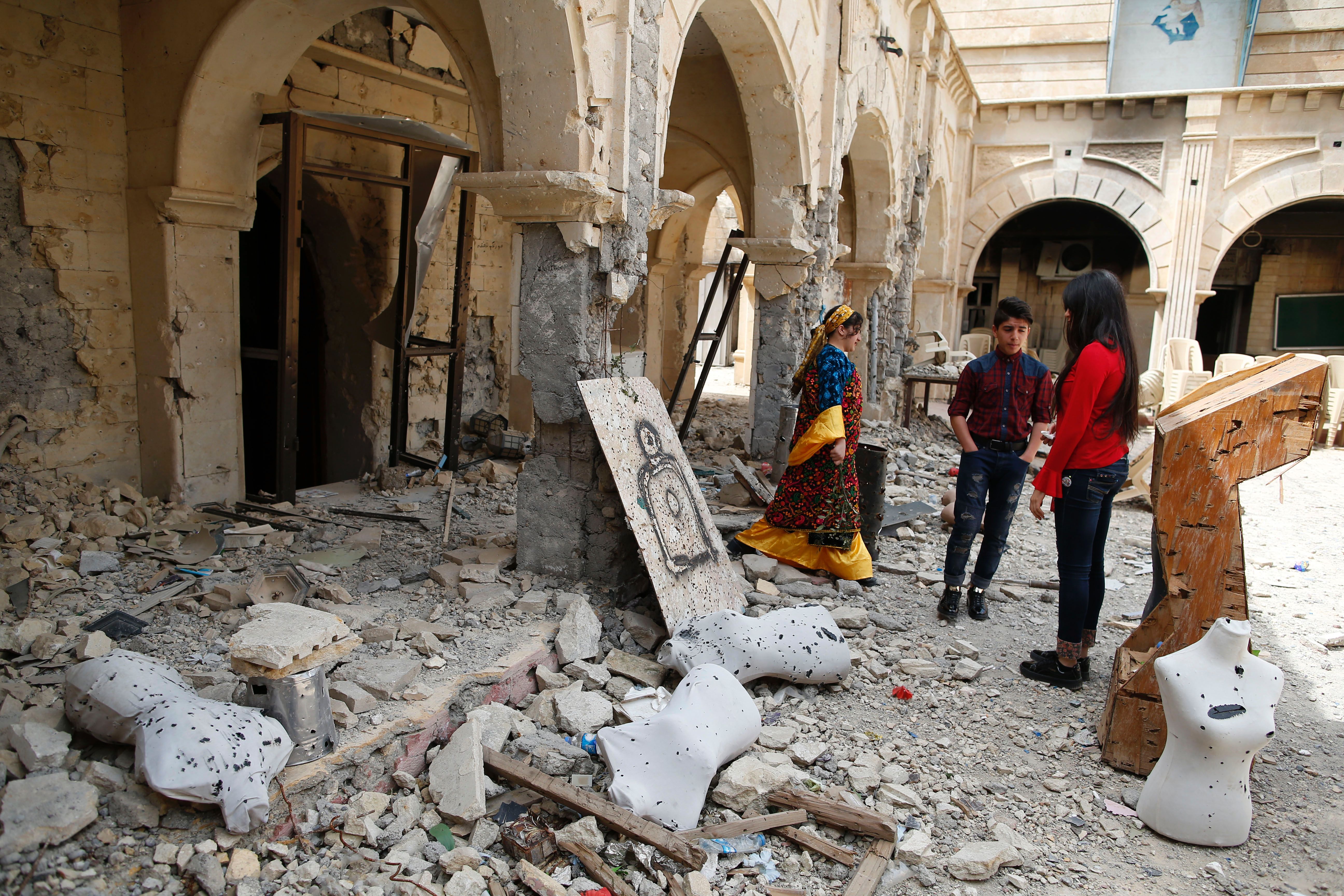 Iraqi Christian residents of Qaraqosh (also known as Hamdaniya), some 30 kilometres east of Mosul, visit the heavily damaged Church of the Immaculate Conception (AHMAD GHARABLI/AFP via Getty Images)