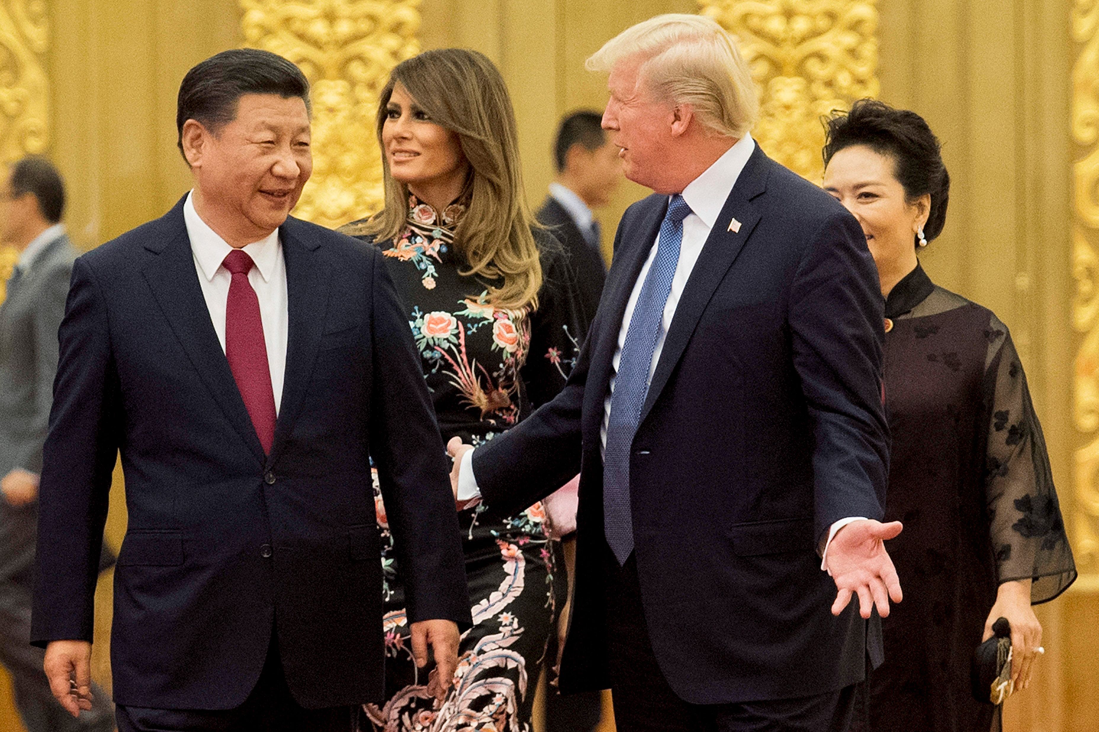US President Donald Trump (2nd R) speaks to China's President Xi Jinping (L) in front of US First Lady Melania Trump (2nd L) and Xi's wife Peng Liyuan (R) in the Great Hall of the People in Beijing on November 9, 2017. Donald Trump urged Chinese leader Xi Jinping to work hard and act fast to help resolve the North Korean nuclear crisis during talks in Beijing Thursday, warning that "time is quickly running out". (Photo: JIM WATSON/AFP via Getty Images)