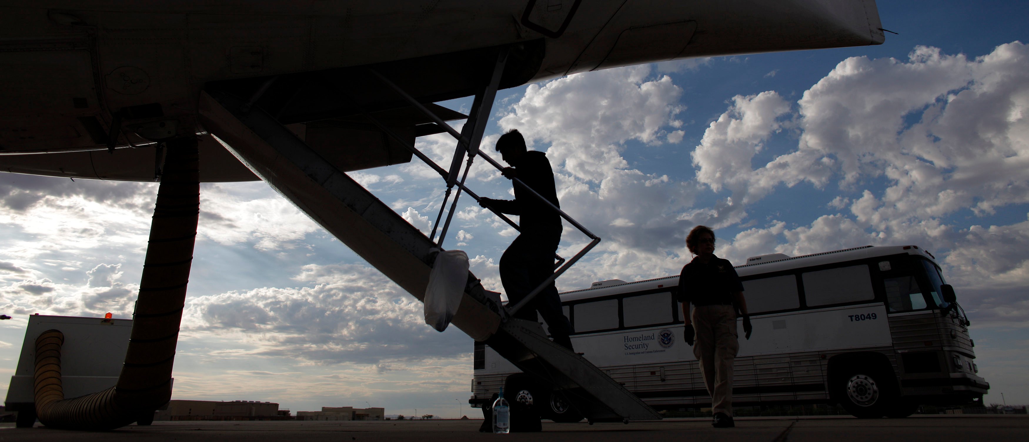 A Guatemalan illegal immigrant boards a plane at a flight operation unit at Mesa airport during his deportation process in Phoenix