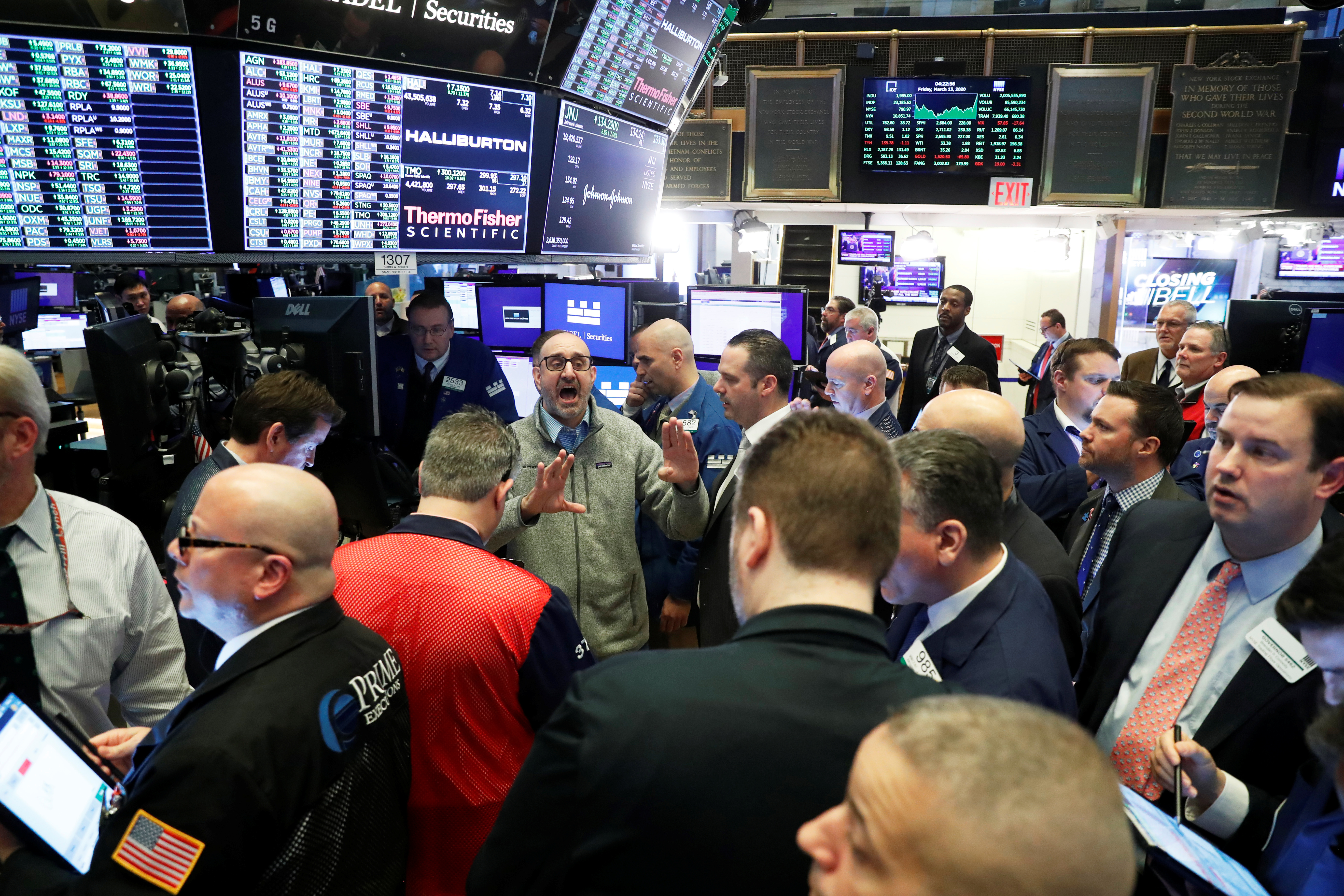 Traders work on the floor of the New York Stock Exchange shortly after the closing bell in New York