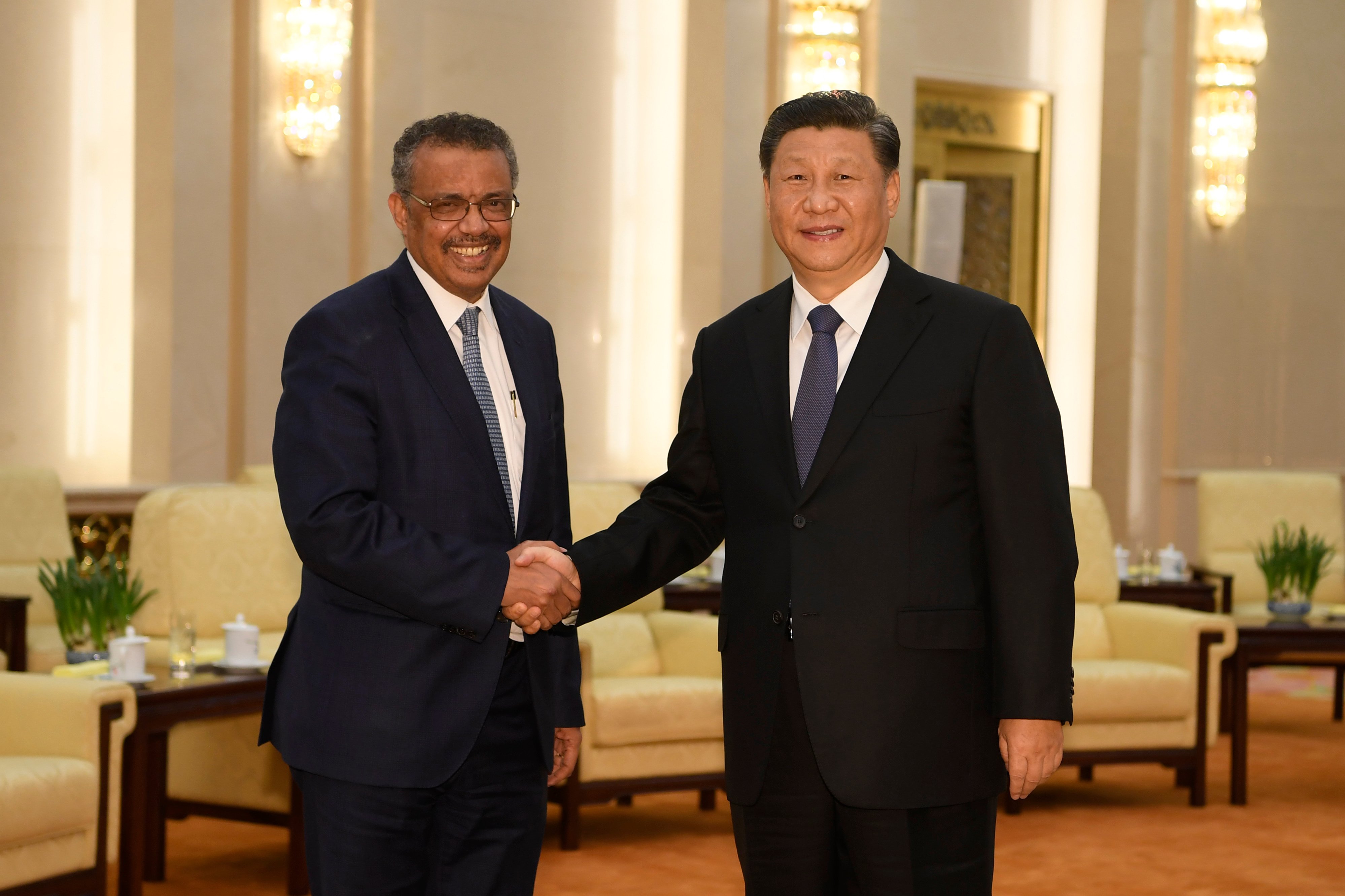 Tedros Adhanom, Director General of the World Health Organization, (L) shakes hands with Chinese President Xi Jinping. (Photo by Naohiko Hatta - Pool/Getty Images)