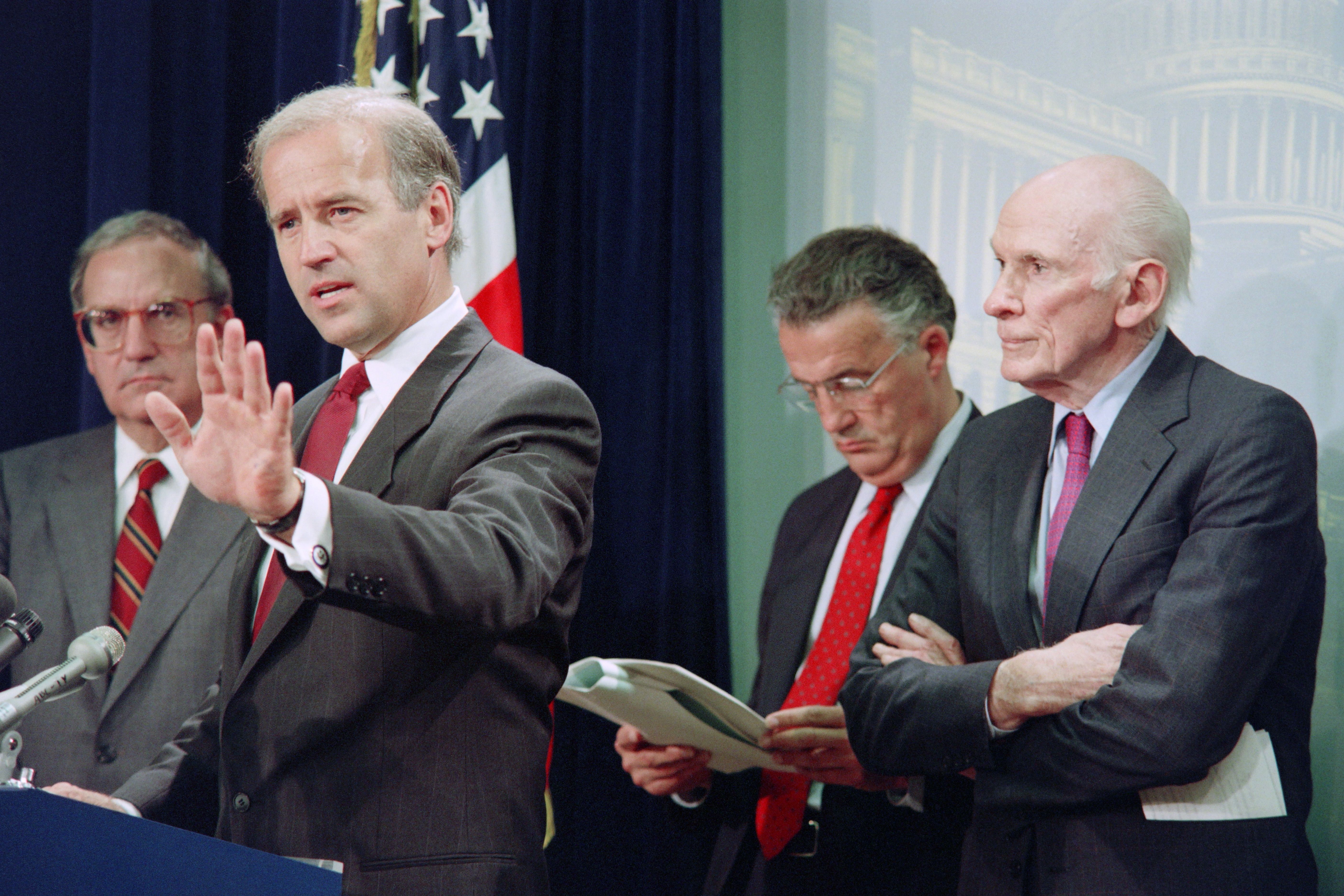 US Senator Joseph Biden, D-Del., talks to reporters on June 25, 1991 on a Senate proposal to scale back conditions for normal trade relations between China and the United States. - The proposal was made by Senate Majority Leadre George Mitchell, D-Maine (L). (Photo by Kevin LARKIN / AFP) (Photo by KEVIN LARKIN/AFP via Getty Images)