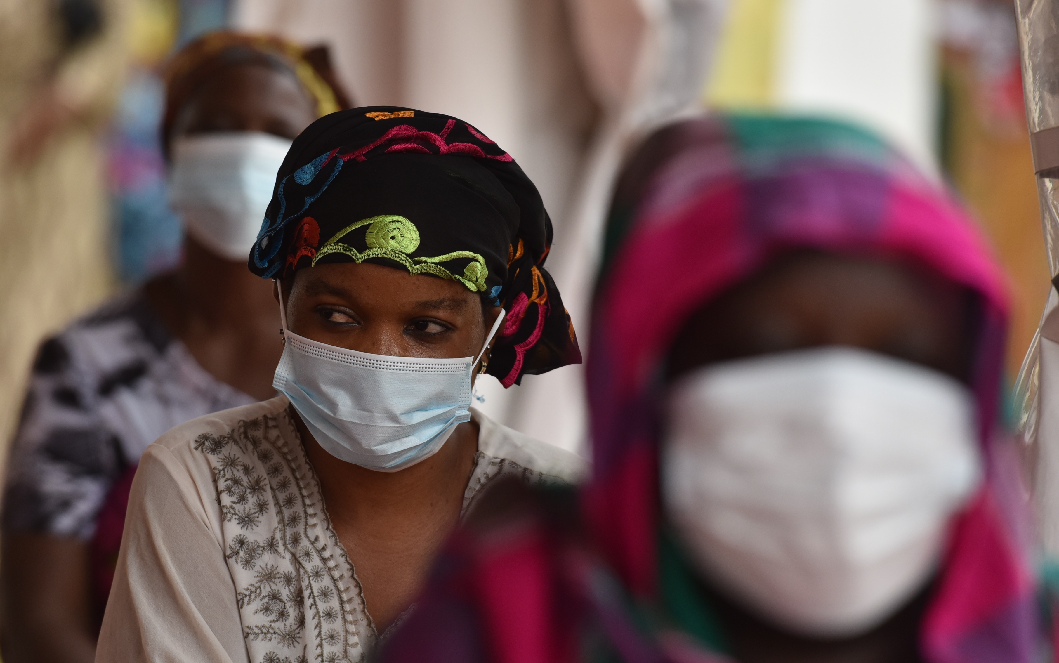 A woman wearing a face mask as a preventive measure against the spread of the COVID-19 coronavirus. (Photo by ISSOUF SANOGO/AFP via Getty Images)