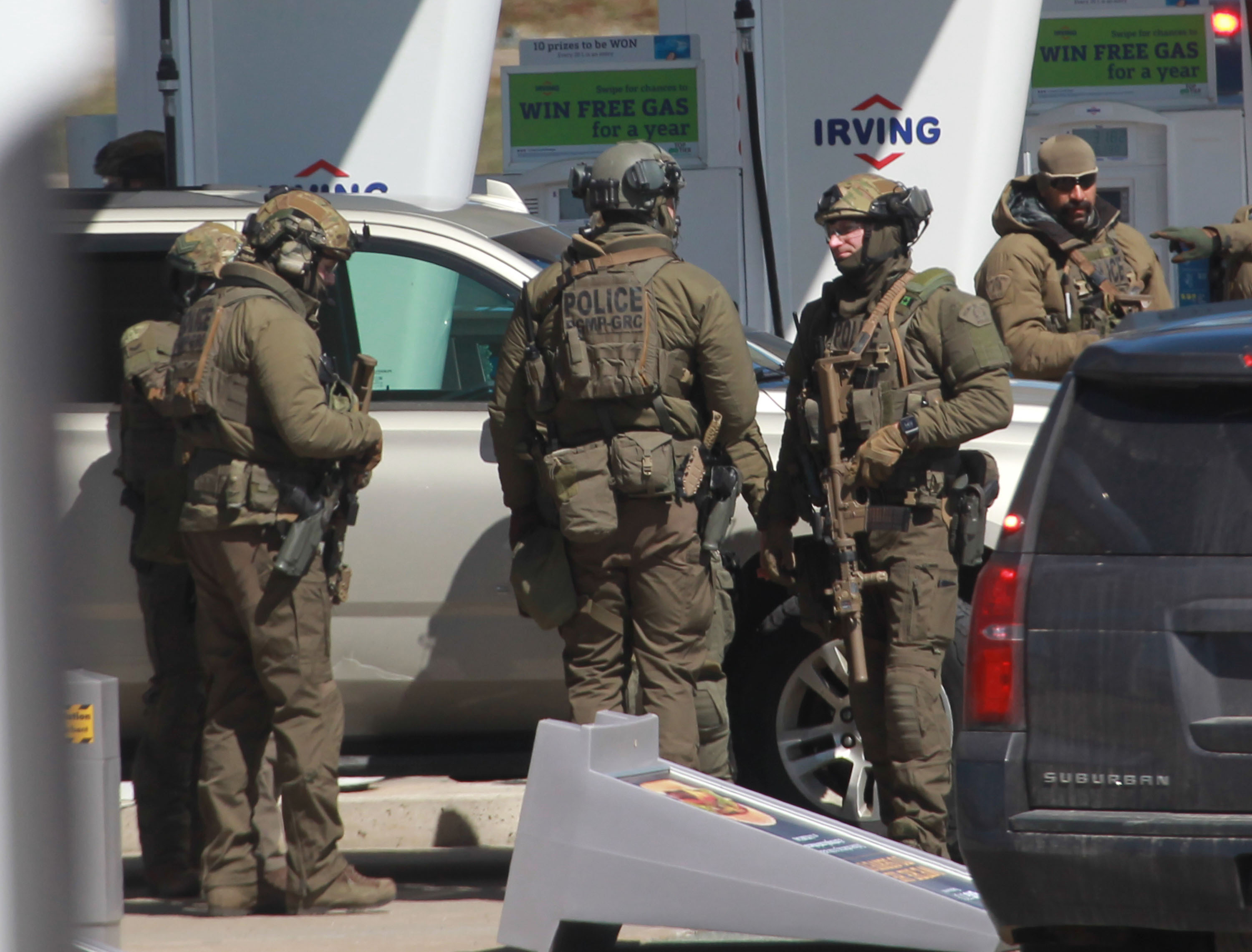 Members of the Royal Canadian Mounted Police (RCMP) tactical unit confer after the suspect in a deadly shooting rampage was neutralized at the Big Stop near Elmsdale, Nova Scotia, Canada, on April 19, 2020. (TIM KROCHAK/AFP via Getty Images)
