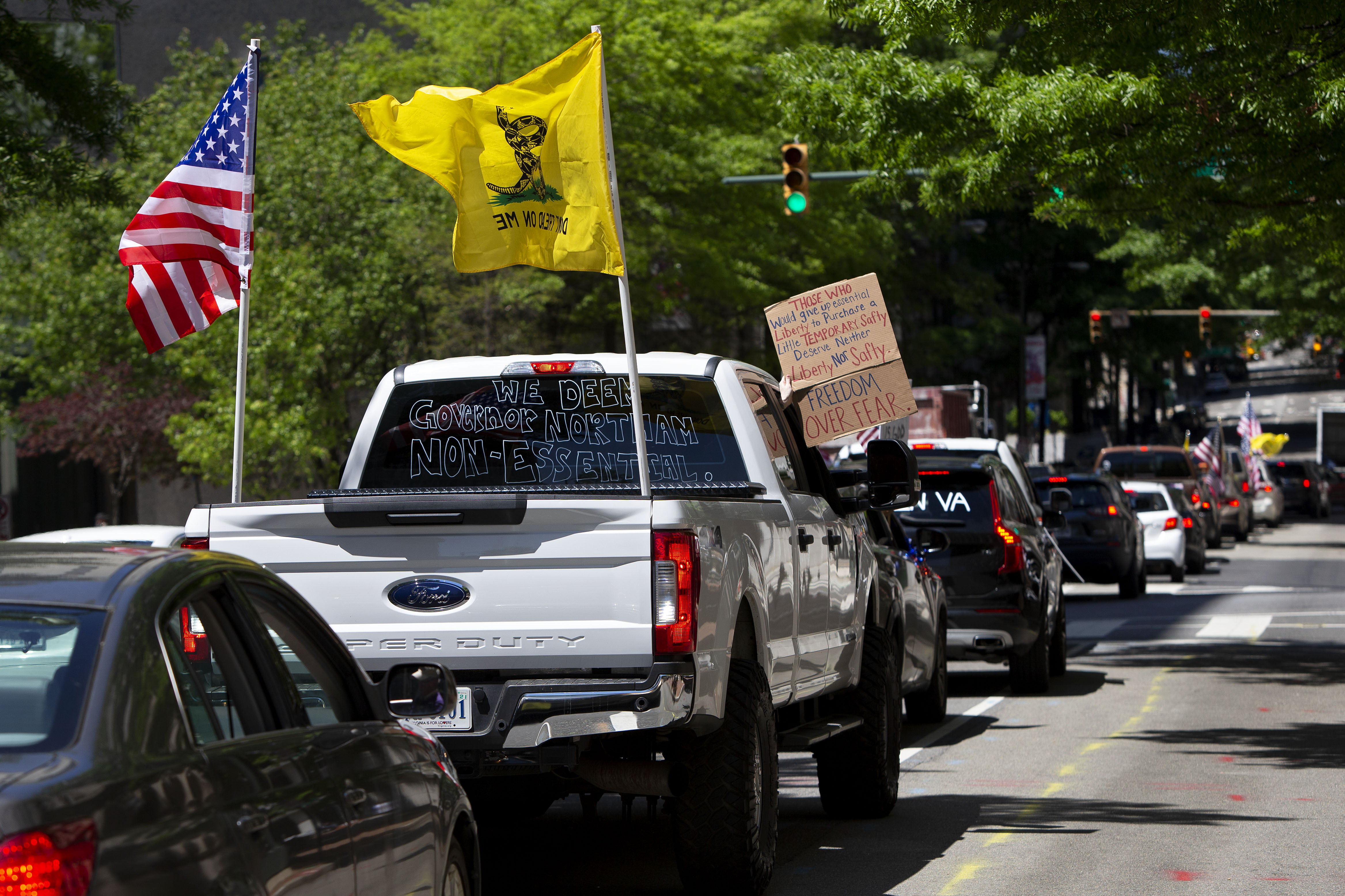 Drivers honk their horns during a reopen Virginia rally around Capitol Square in Richmond on April 22, 2020. (Photo by RYAN M. KELLY/AFP via Getty Images)