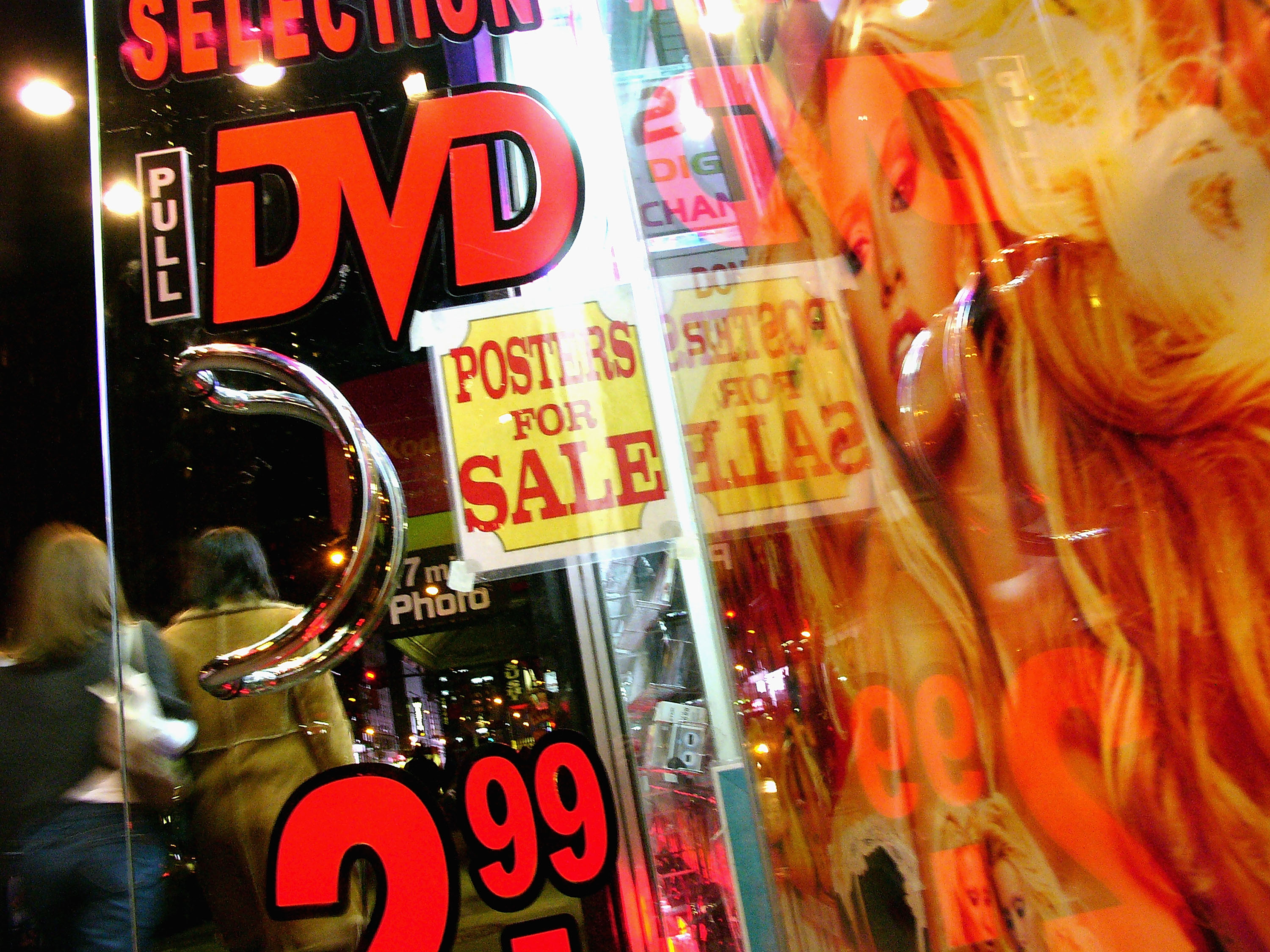 Pedestrians pass an adult video store in Times Square March 15, 2005 in New York City. (Photo by Spencer Platt/Getty Images)