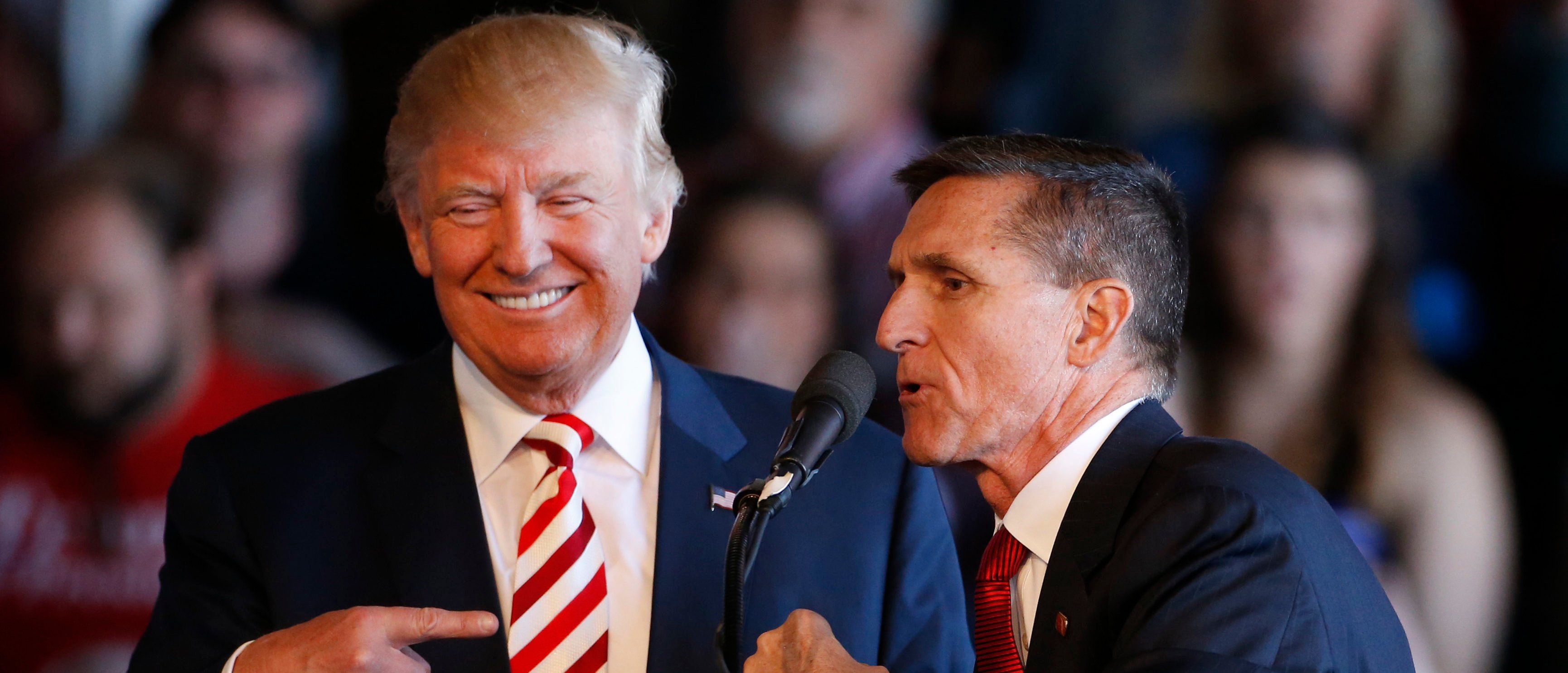 GRAND JUNCTION, CO - OCTOBER 18: Republican presidential candidate Donald Trump (L) jokes with retired Gen. Michael Flynn as they speak at a rally at Grand Junction Regional Airport on October 18, 2016 in Grand Junction Colorado. Trump is on his way to Las Vegas for the third and final presidential debate against Democratic rival Hillary Clinton. (Photo by George Frey/Getty Images)