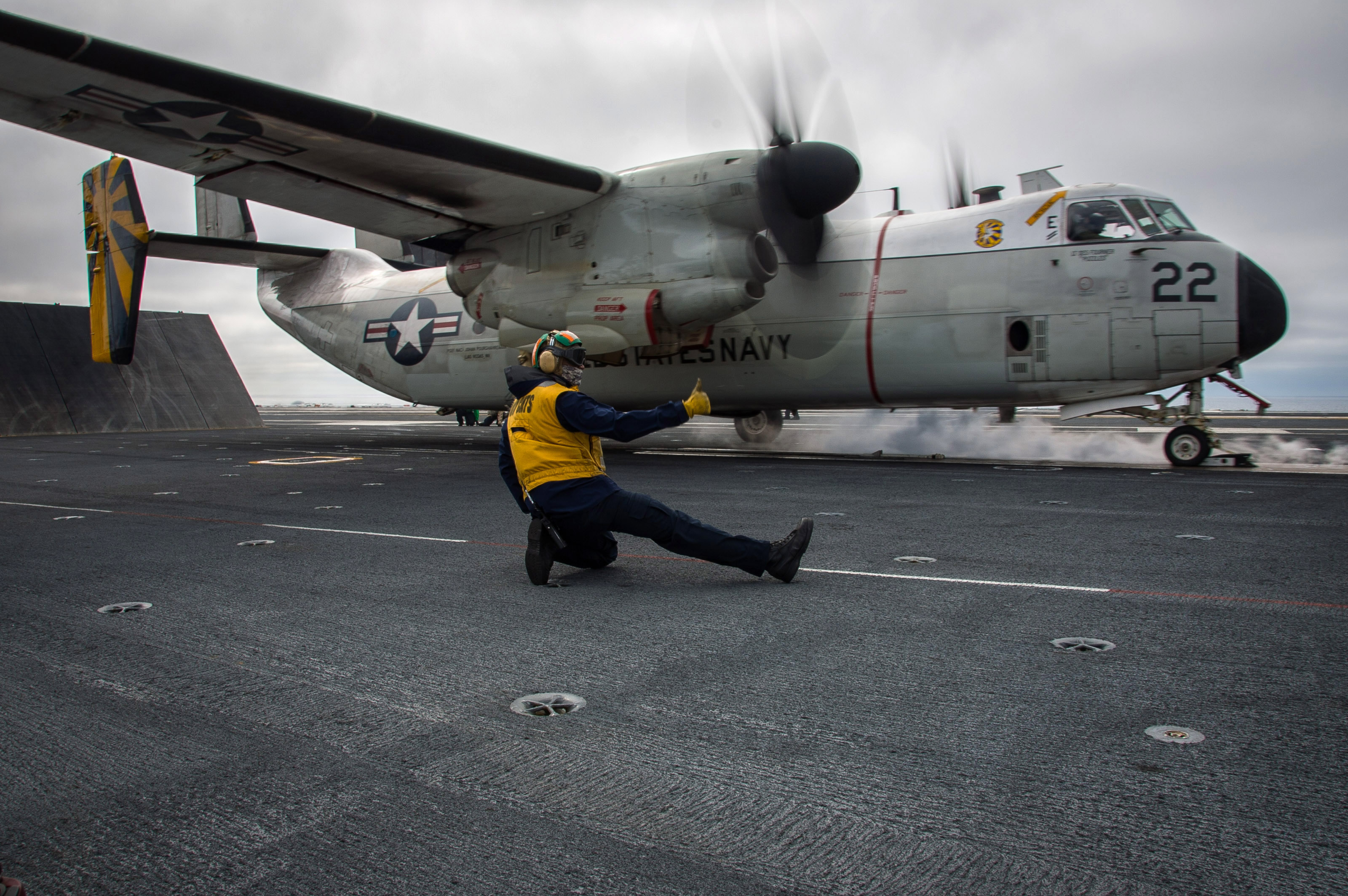 In this U.S. Navy handout, Aviation Boatswain's Mate (Equipment) 2nd Class Chad Cole signals for a C-2A Greyhound logistics aircraft assigned to the "Providers" of Fleet Logistics Support Squadron (VRC) 30 to take off from the flight deck of the USS Theodore Roosevelt (CVN 71) on February 10, 2017 in the Pacific Ocean. (Mass Communication Specialist Seaman Alex Corona/U.S. Navy via Getty Images)