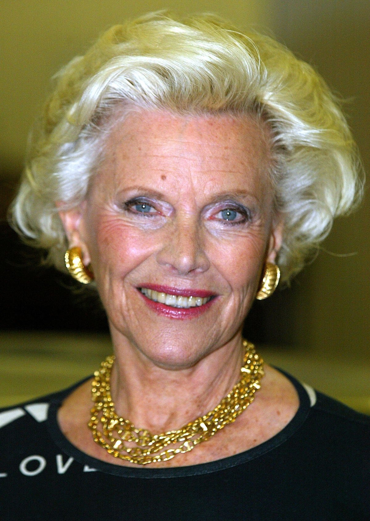 Actress Honor Blackman who played the part of Pussy Galore in the film "Goldfinger" poses for photographers at the Bond, James Bond exhibition October 15, 2002 in London, United Kingdom. The exhibition explores the Bond films through the most extensive collection of original 007 objects, images, concept drawings, storyboards and costume designs ever assembled. (Photo by Scott Barbour/Getty Images)