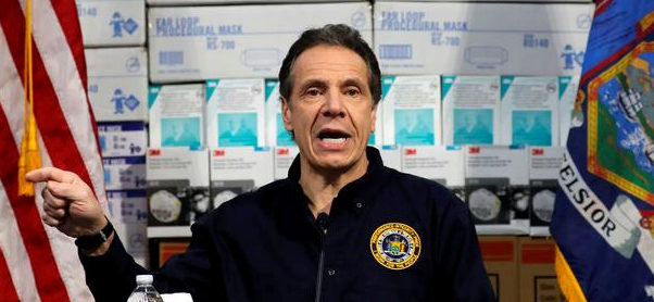 New York Governor Andrew Cuomo speaks in front of stacks of medical protective supplies. March 24, 2020. REUTERS/Mike Segar/File Photo