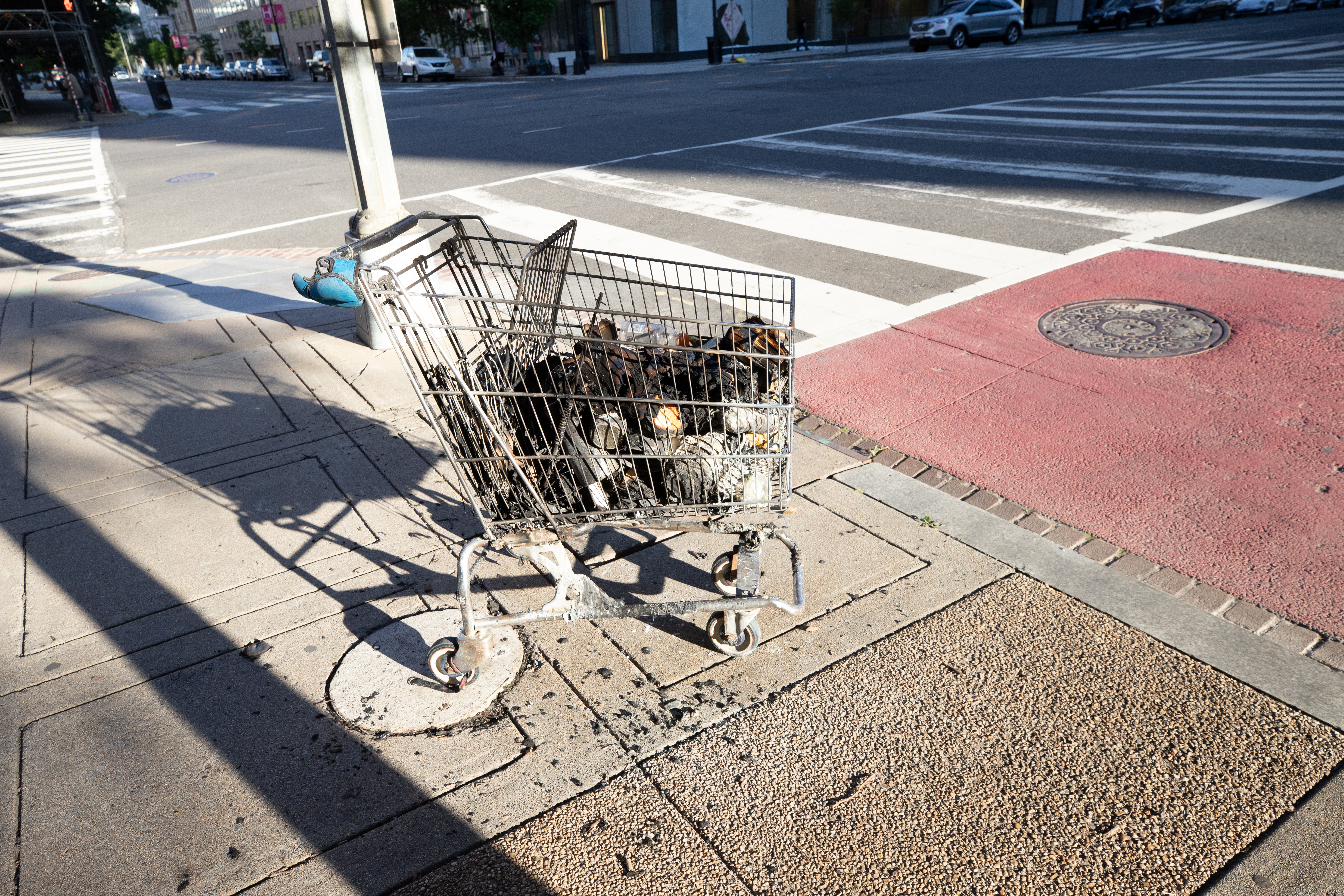 A shopping cart containing the remnants of a fire of of Connecticut Ave. NW and H St. NW. (Photo: Kaylee C. Greenlee for The Daily Caller)