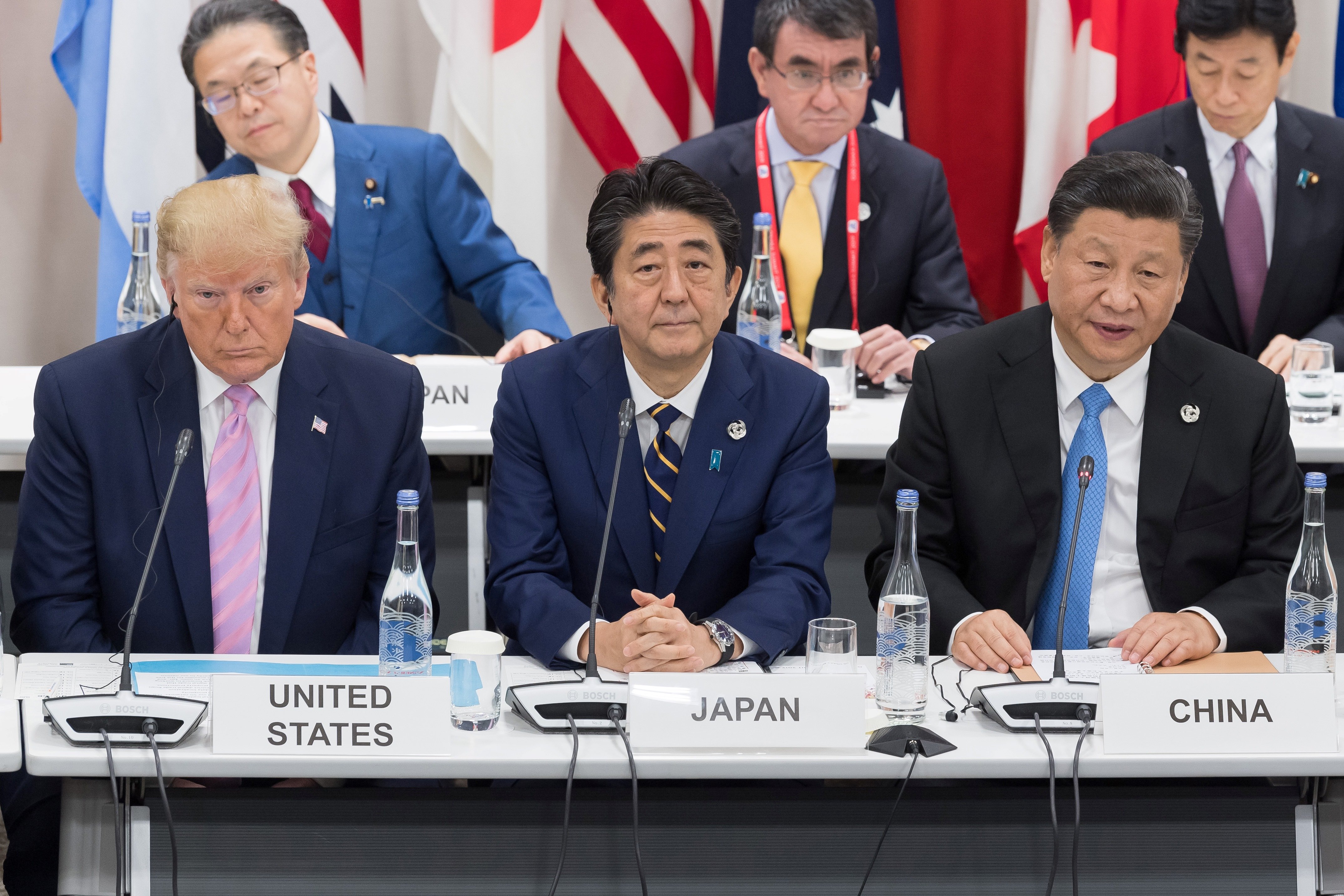 US President Donald Trump (L) sits with Japan's Prime Minister Shinzo Abe (C) and China's President Xi Jinping as they attend a meeting on the digital economy at the G20 Summit in Osaka on June 28, 2019. (JACQUES WITT/AFP via Getty Images)