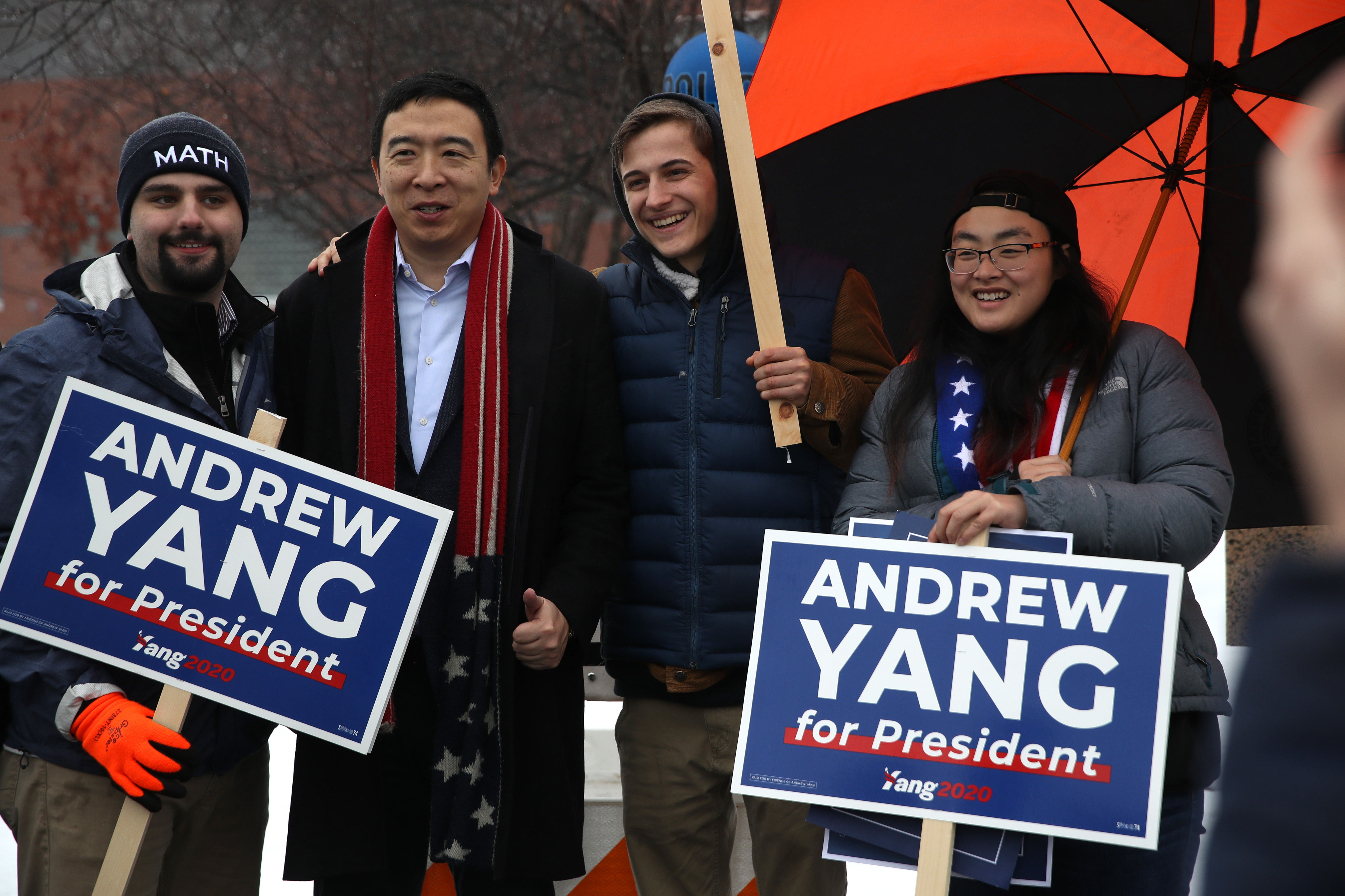 Democratic presidential candidate Andrew Yang take a photo with supporters who are holding campaign signs in front of a polling station on February 11, 2020 in Keene, New Hampshire. (Photo by Justin Sullivan/Getty Images)