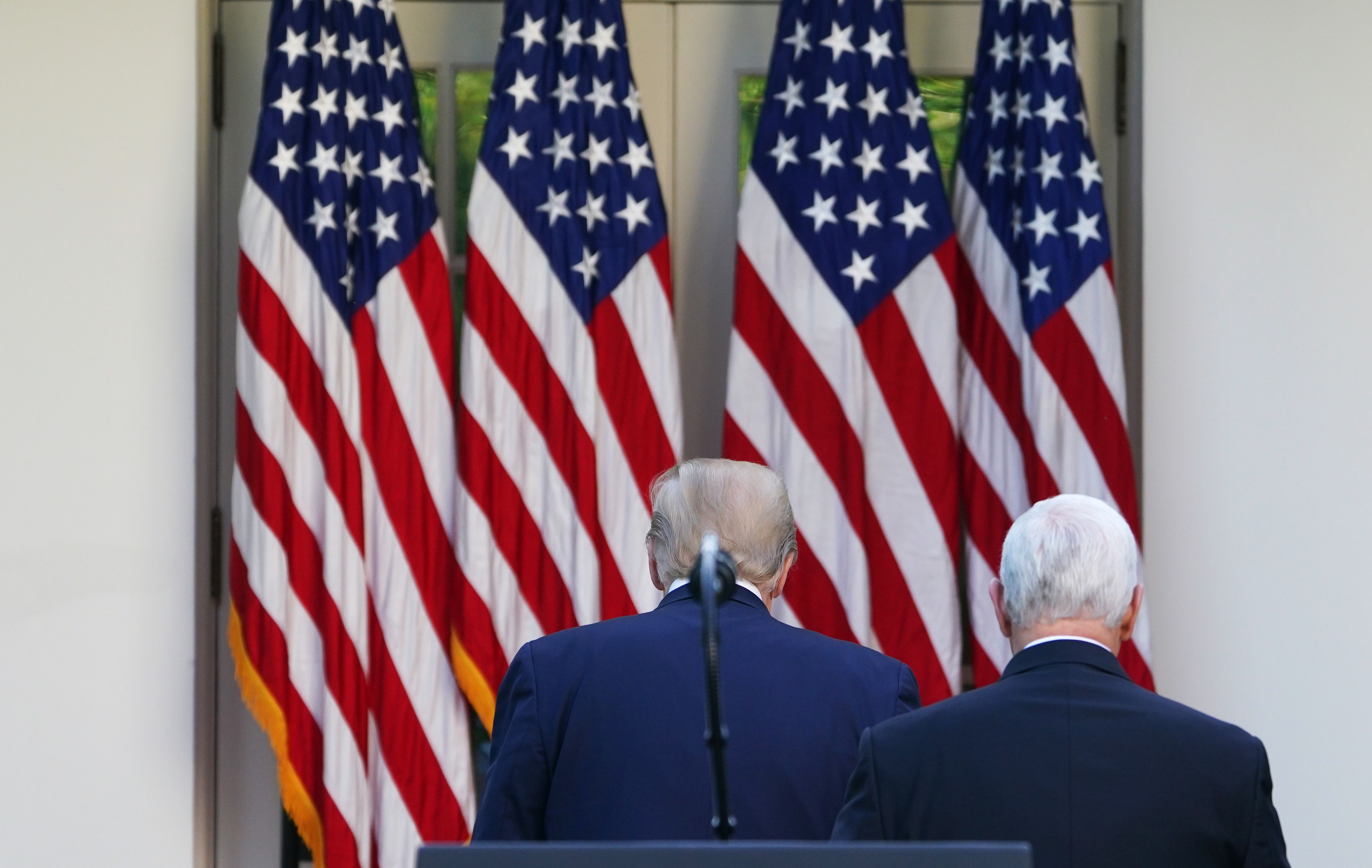 US President Donald Trump (L) and US Vice President Mike Pence return to the Oval Office after a press conference on the novel coronavirus, COVID-19, in the Rose Garden of the White House in Washington, DC on April 27, 2020. (Photo by MANDEL NGAN/AFP via Getty Images)