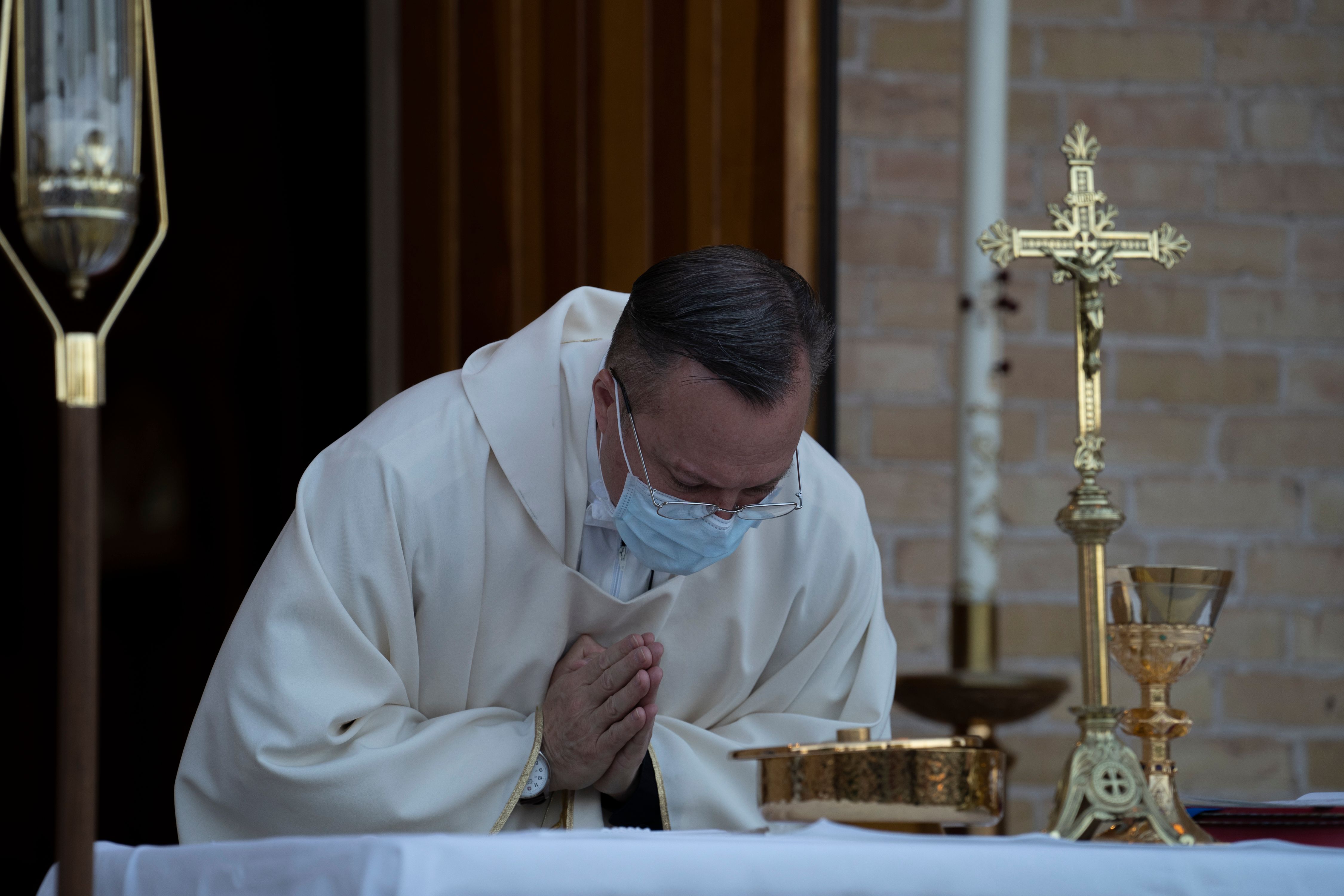 Father Christoper Williams of the Basilica of San Albino performs the Eucharist during an outdoor mass on May 2, 2020 in Mesilla, New Mexico, amid the coronavirus pandemic. - (Photo by PAUL RATJE/AFP via Getty Images)