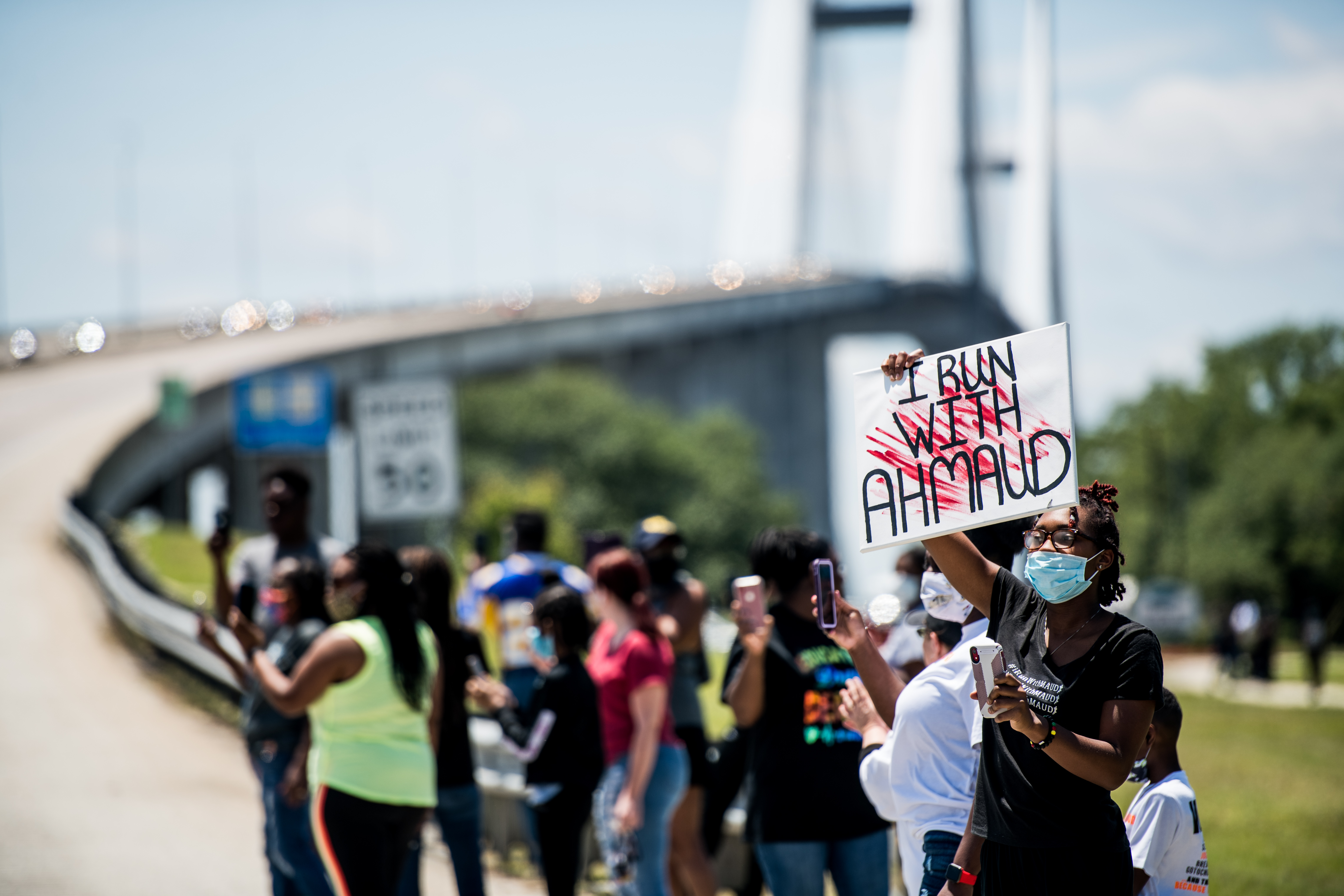 Demonstrators watch a parade of passing motorcyclists riding in honor of Ahmaud Arbery at Sidney Lanier Park on May 9, 2020 in Brunswick, Georgia. (Photo by Sean Rayford/Getty Images)