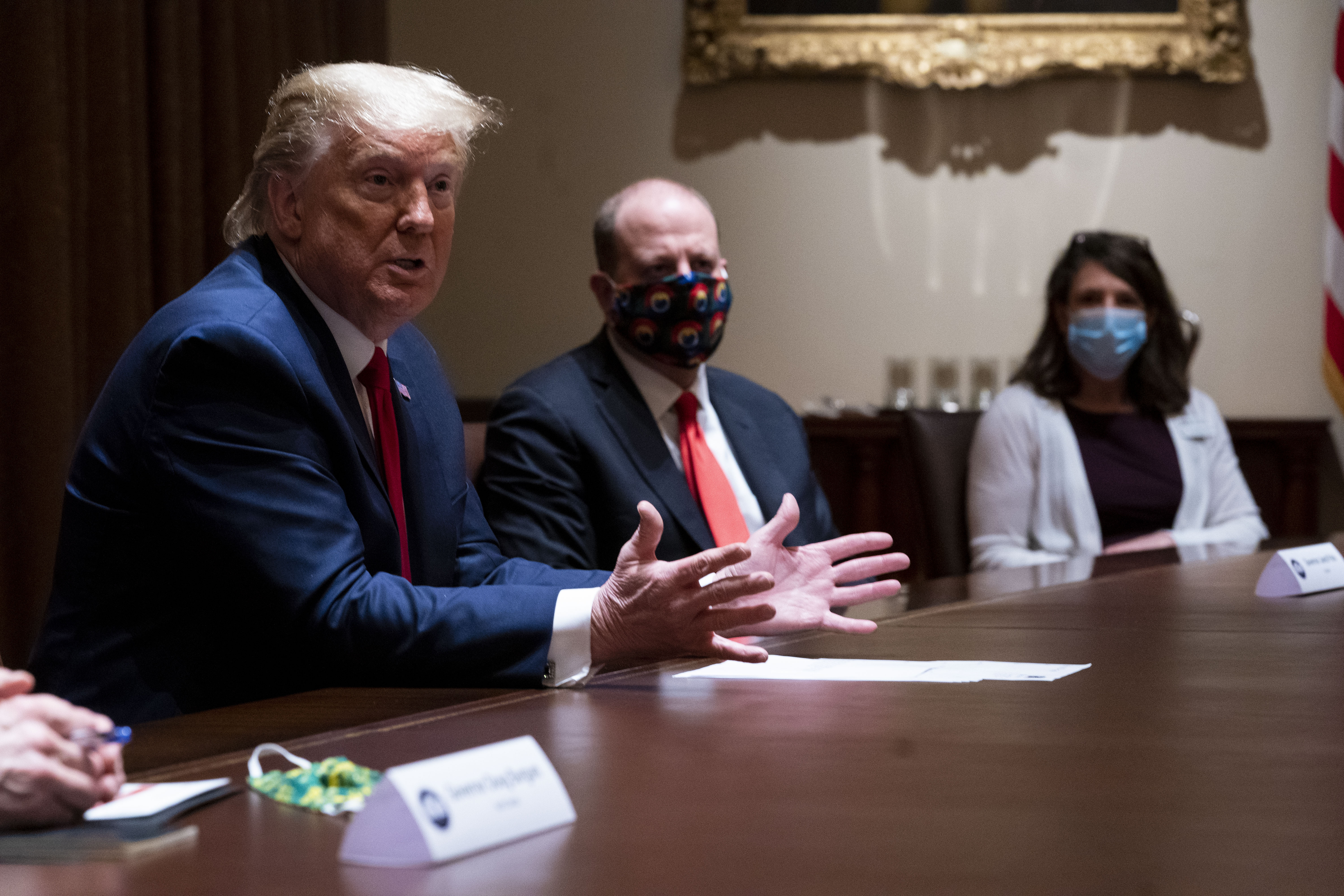 WASHINGTON, DC - MAY 13: Colorado Governor Jared Polis (C) wears a face mask as U.S. President Donald Trump makes remarks during a meeting in the Cabinet Room of the White House, May 13, 2020 in Washington, DC. (Photo by Doug Mills-Pool/Getty Images)