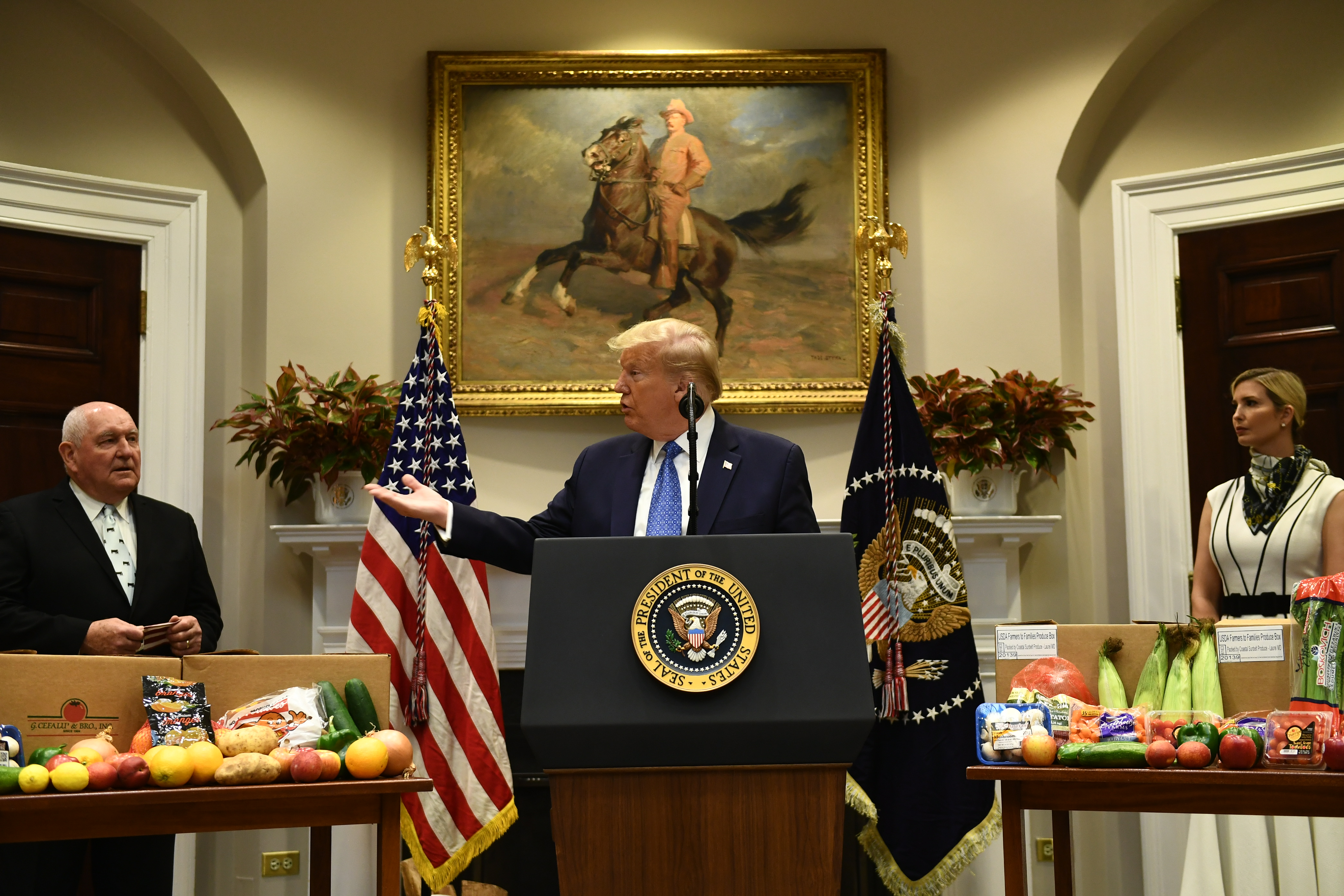 US President Donald Trump, with Senior Advisor to the President Ivanka Trump (R) and Agriculture Secretary Sonny Perdue, speaks about the food supply chain during the coronavirus pandemic, in the Roosevelt Room of the White House on May 19, 2020, in Washington, DC.  (Photo by BRENDAN SMIALOWSKI/AFP via Getty Images)