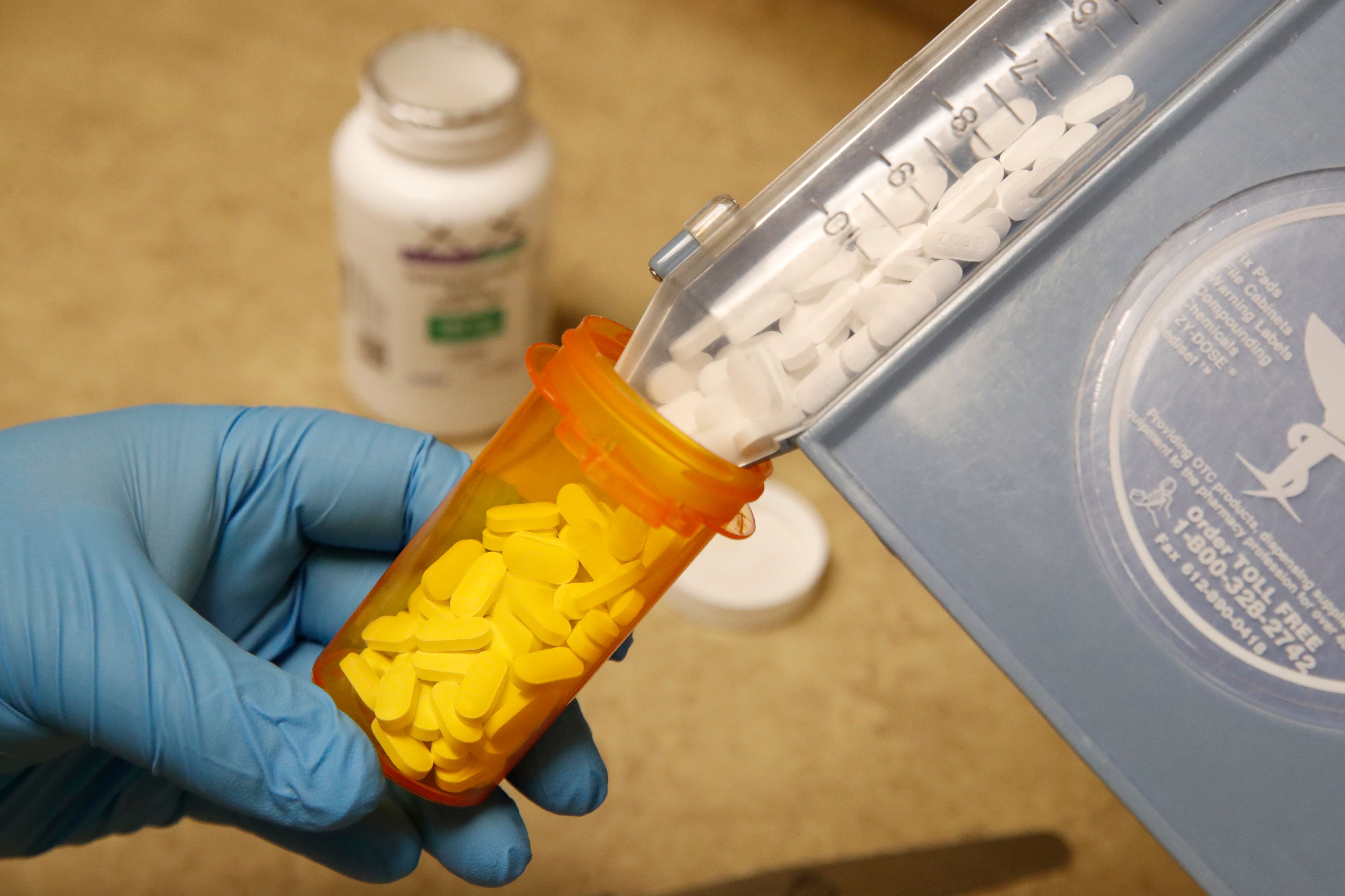 A pharmacy tech puts pills of Hydroxychloroquine in a bottle at Rock Canyon Pharmacy in Provo, Utah, on May 20, 2020. (GEORGE FREY/AFP via Getty Images)
