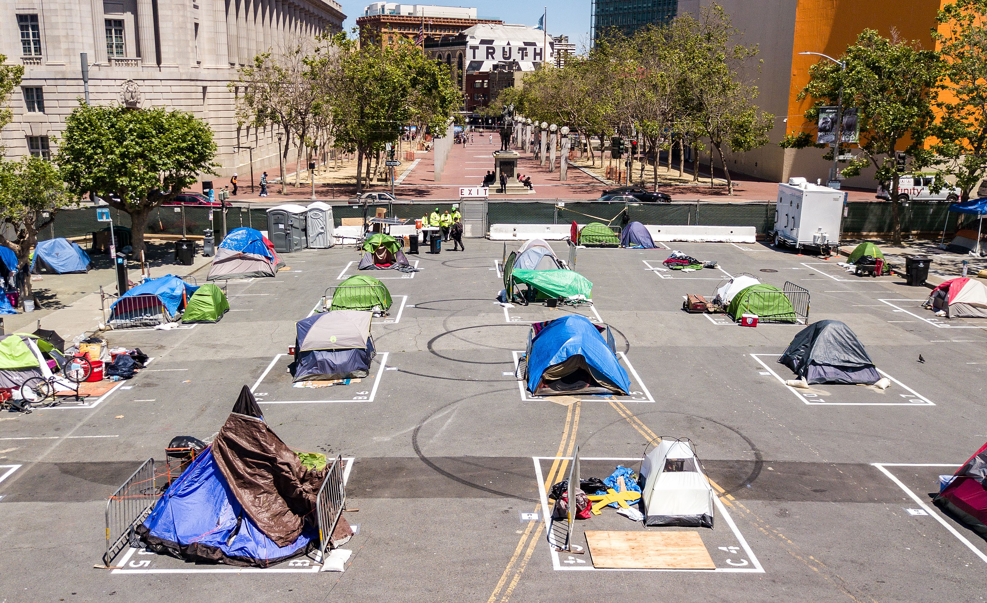 Rectangles are painted on the ground to encourage homeless people to keep social distancing at a city-sanctioned homeless encampment across from City Hall in San Francisco, California, on May 22, 2020, amid the novel coronavirus pandemic. (Photo by JOSH EDELSON/AFP via Getty Images)