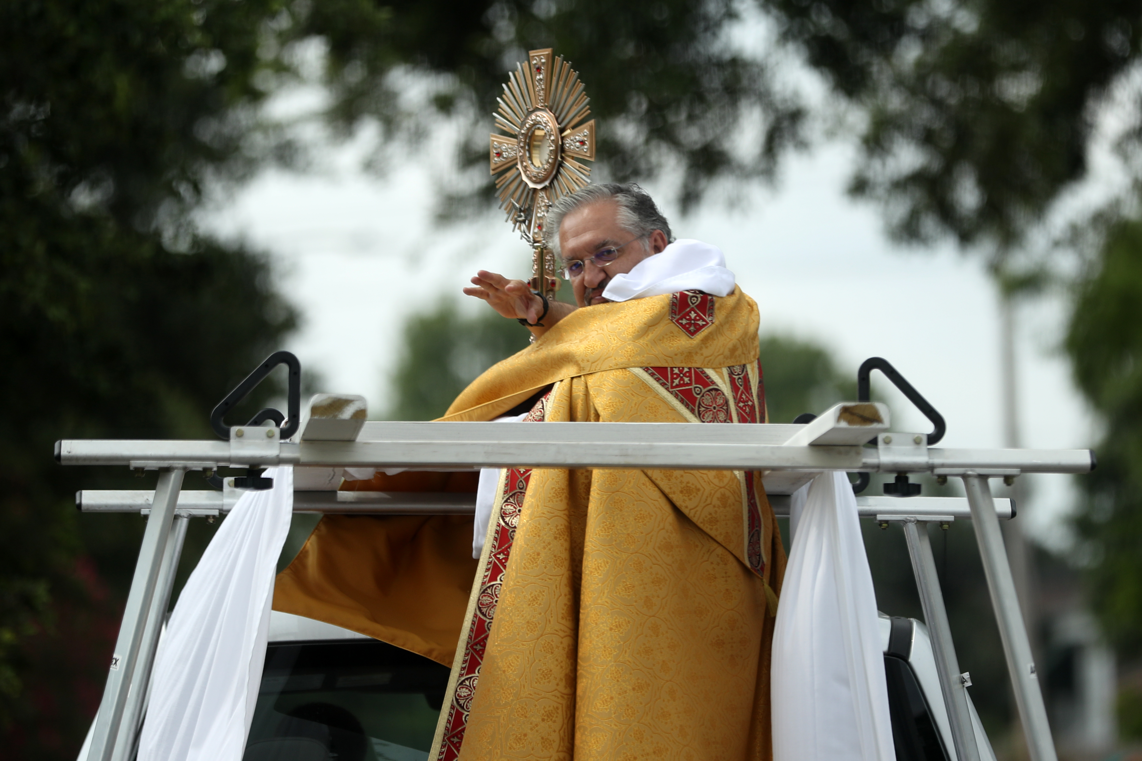 Rev. John G. Restrepo, O.P., V.F., pastor of St. Dominic Catholic Church, rides in a truck with the Hope Monstrance on Holy Wednesday to bless residents in the Lakeview neighborhood on April 08, 2020 in New Orleans, Louisiana. (Photo by Chris Graythen/Getty Images)