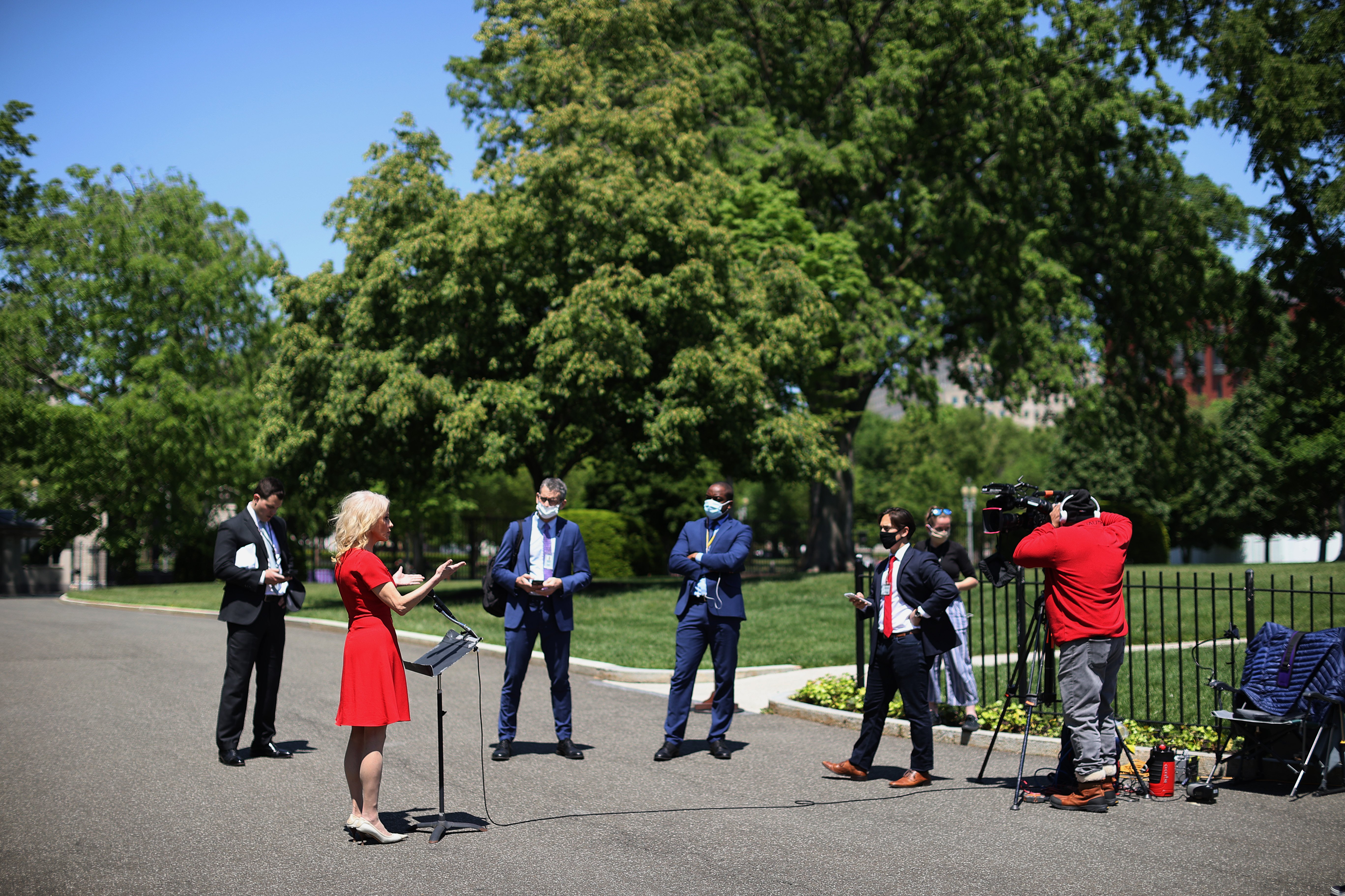 WASHINGTON, DC - MAY 07: Reporters maintain social distancing due to the novel coronavirus pandemic while asking White House Counselor to the President Kellyanne Conway questions outside the White House May 07, 2020 in Washington, DC. Conway participated in three television interviews before talking to the reporters. (Photo by Chip Somodevilla/Getty Images)