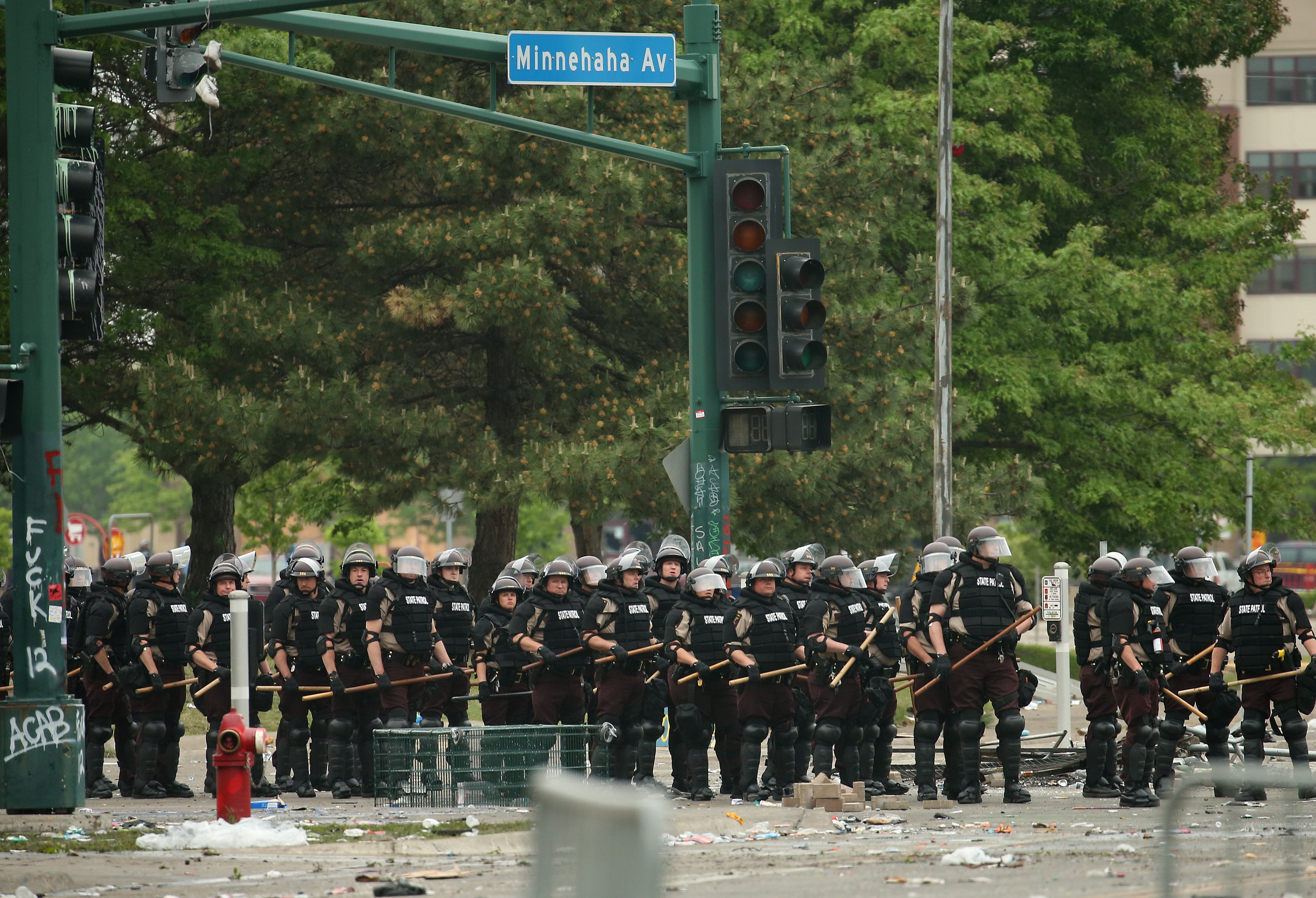MINNEAPOLIS, MINNESOTA - MAY 29: Police carrying batons hold a line on the fourth day of protests on May 29, 2020 in Minneapolis, Minnesota. The National Guard has been activated as protests continue after the death of George Floyd which has caused widespread destruction and fires across Minneapolis and St. Paul. (Photo by Scott Olson/Getty Images)