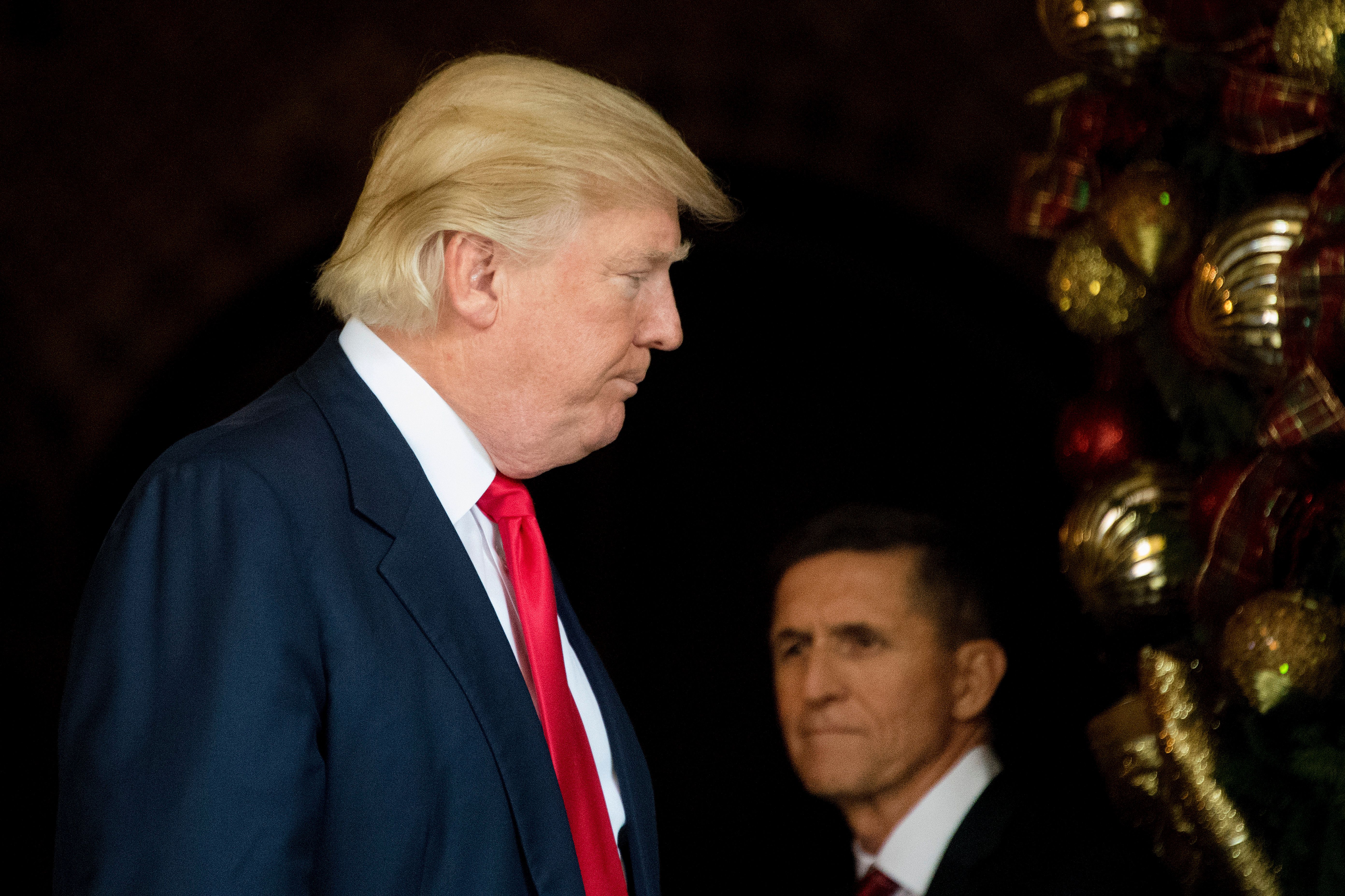 US President-elect Donald Trump (L) stands with Trump National Security Adviser Lt. General Michael Flynn (R) at Mar-a-Lago in Palm Beach, Florida, where he is holding meetings on December 21, 2016. (JIM WATSON/AFP via Getty Images)