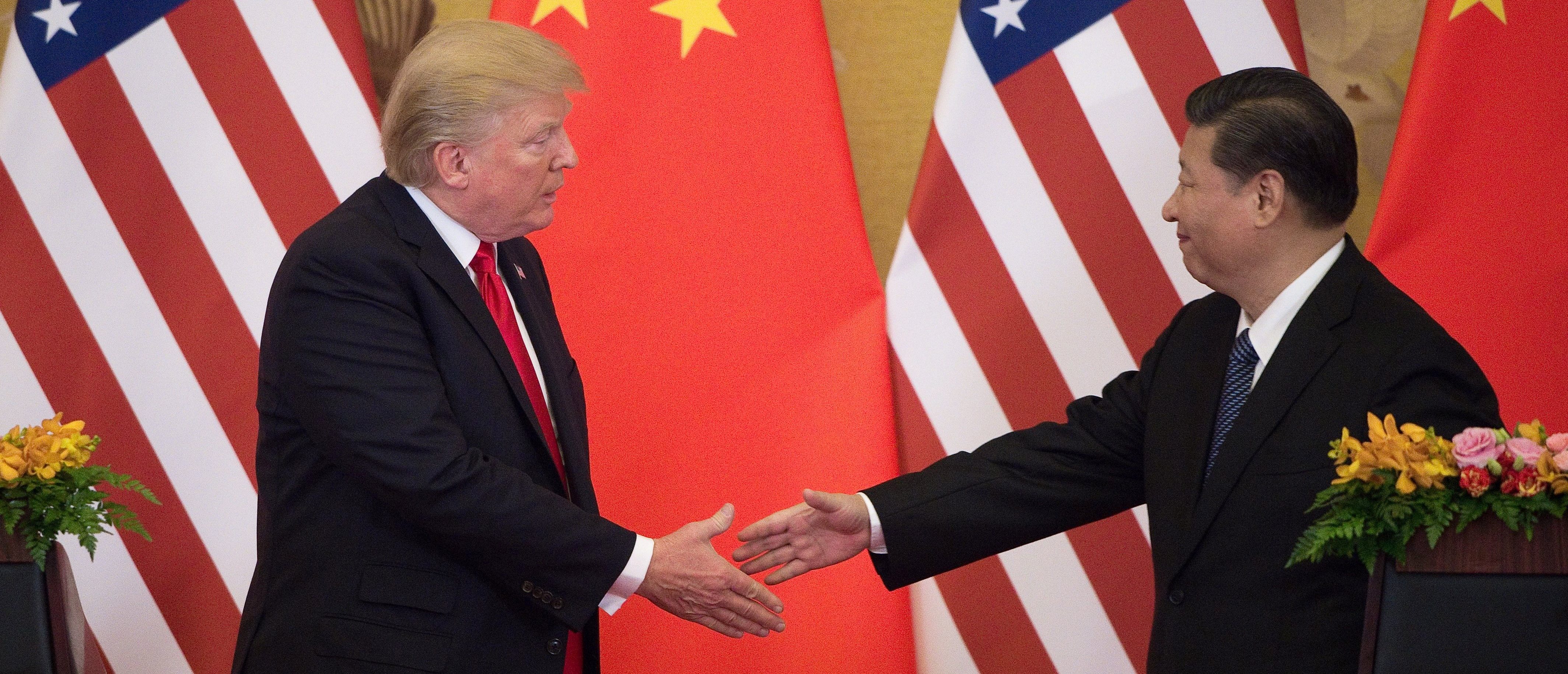 US President Donald Trump (L) shakes hands with China's President Xi Jinping at the end of a press conference at the Great Hall of the People in Beijing on November 9, 2017. Donald Trump urged Chinese leader Xi Jinping to work "hard" and act fast to help resolve the North Korean nuclear crisis, during their meeting in Beijing Thursday, warning that "time is quickly running out". / AFP PHOTO / Nicolas ASFOURI (Photo credit should read NICOLAS ASFOURI/AFP via Getty Images)