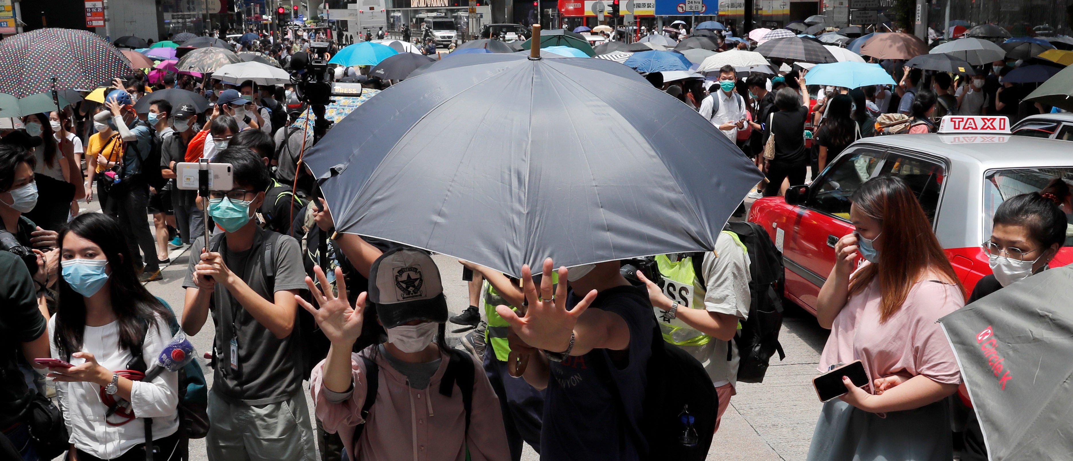 People wearing face masks take part in a protest against the second reading of a controversial national anthem law in Hong Kong, China May 27, 2020. REUTERS/Tyrone Siu - RC2UWG9P3TP6