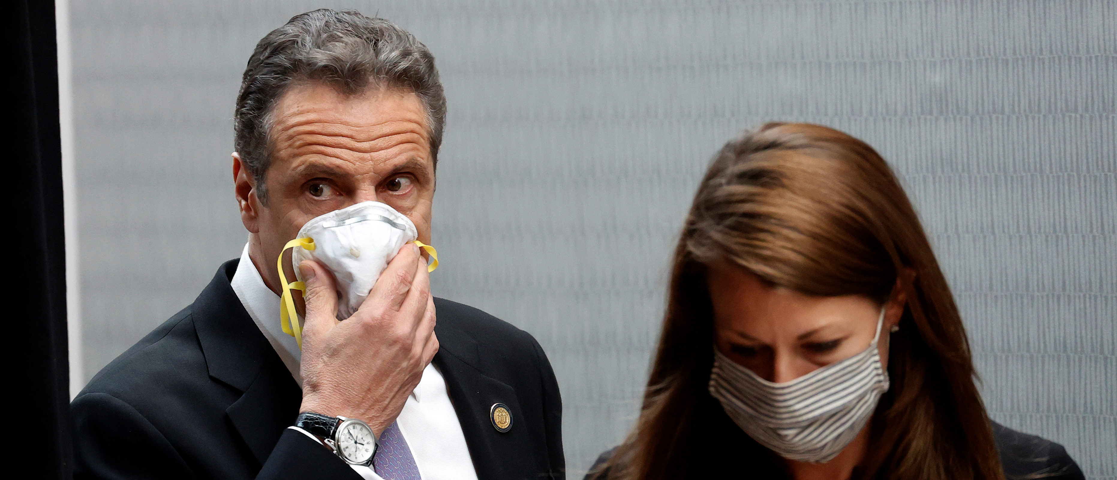 New York Governor Andrew Cuomo holds a protective mask to his face as he and Secretary to the Governor Melissa DeRosa arrive for a daily briefing at New York Medical College during the outbreak of the coronavirus disease (COVID-19) in Valhalla, New York, U.S., May 7, 2020. REUTERS/Mike Segar
