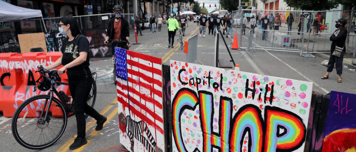 A man attends a protest at the self-proclaimed Capitol Hill Autonomous Zone (CHAZ) during a protest against racial inequality and call for defunding of Seattle police, in Seattle, Washington, U.S. June 14, 2020.