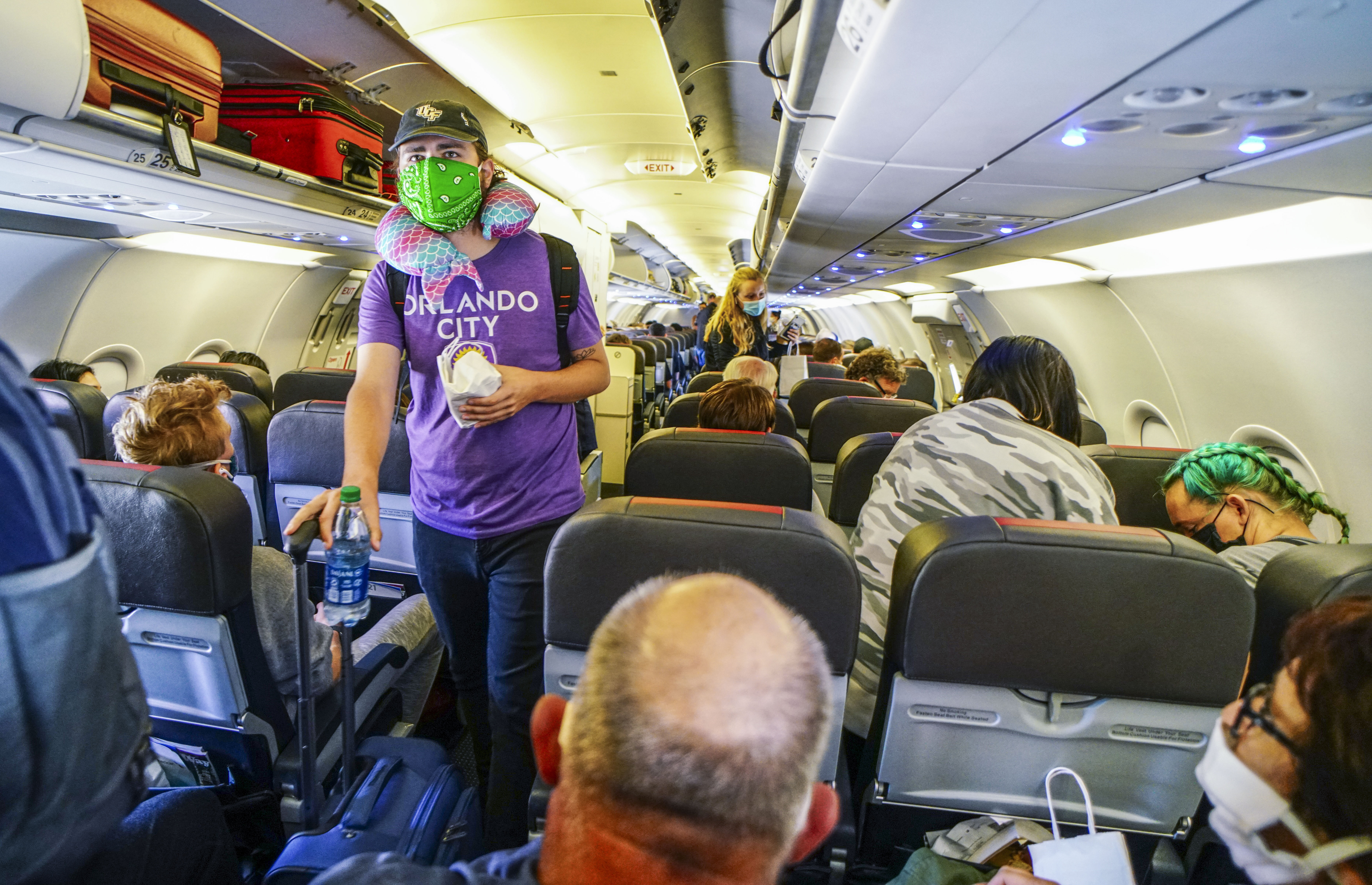 SAN DIEGO, CA-MAY 20: Passengers board an American Airlines flight to Charlotte, North Carolina at San Diego International Airport on May 20, 2020 in San Diego, California. Air travel is down as estimated 94 percent due to the coronavirus (COVID-19) pandemic, causing U.S. airlines to take a major financial hit with losses of $350 million to $400 million a day as nearly half of major carriers' planes sit idle. (Photo by Sandy Huffaker/Getty Images)