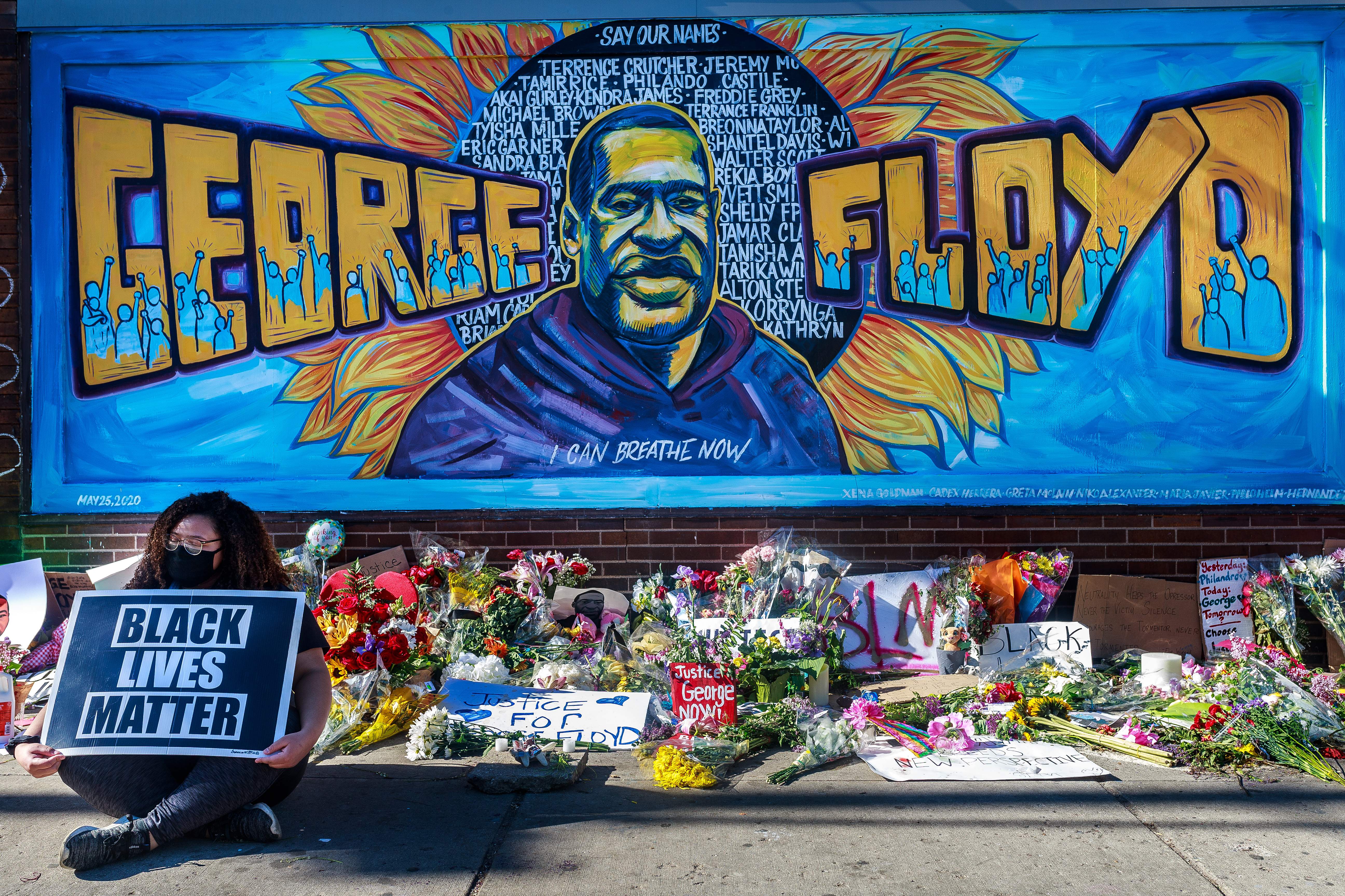 Flowers, signs and balloons are left near a makeshift memorial to George Floyd near the spot where he died while in custody of the Minneapolis police, on May 29, 2020 in Minneapolis, Minnesota. - Demonstrations are being held across the US after George Floyd died in police custody on May 25. (Photo by Kerem Yucel / AFP) (Photo by KEREM YUCEL/AFP via Getty Images)