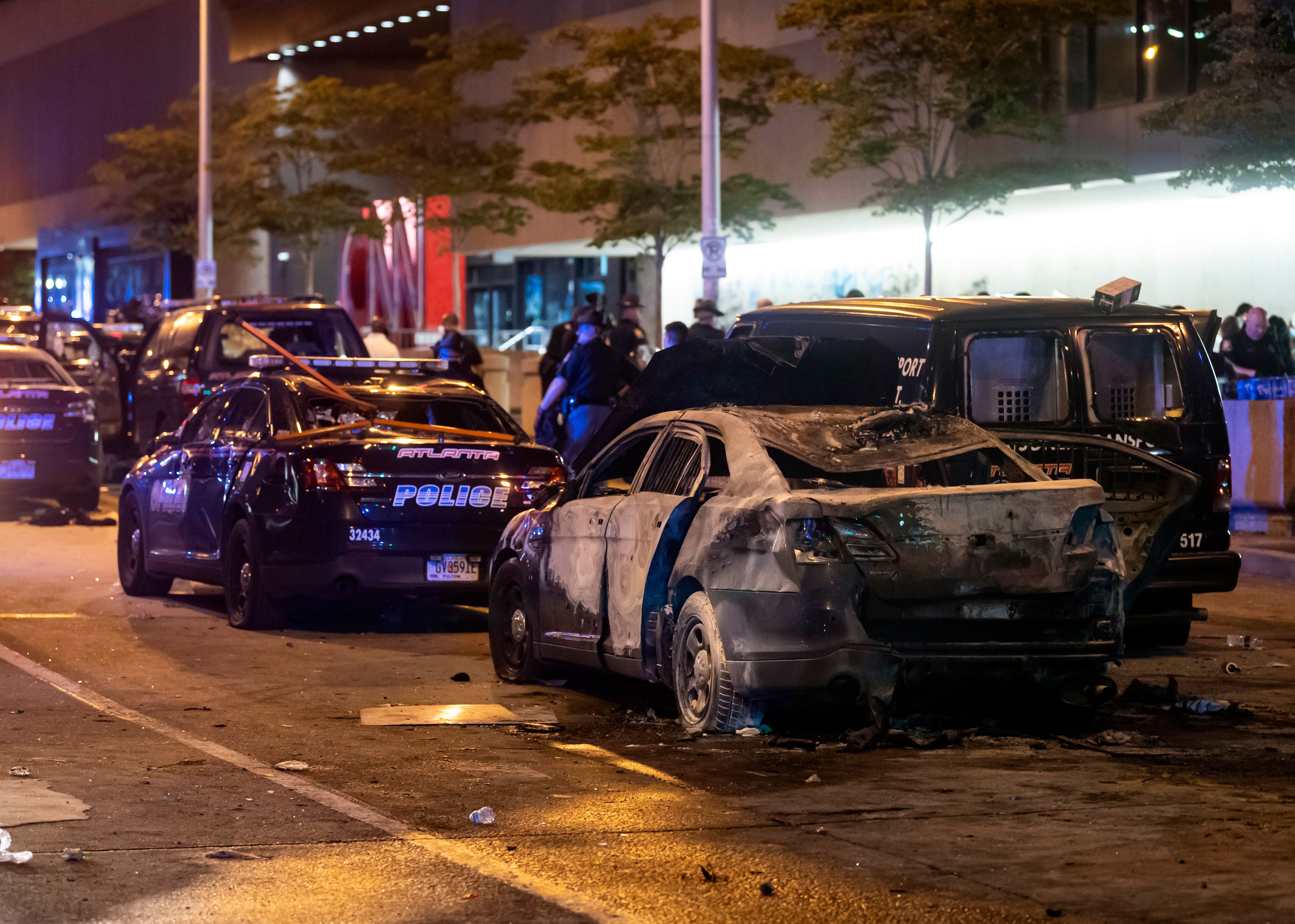 A burned out car sits idle during rioting and protests in Atlanta on May 29, 2020. (Photo by JOHN AMIS/AFP via Getty Images)