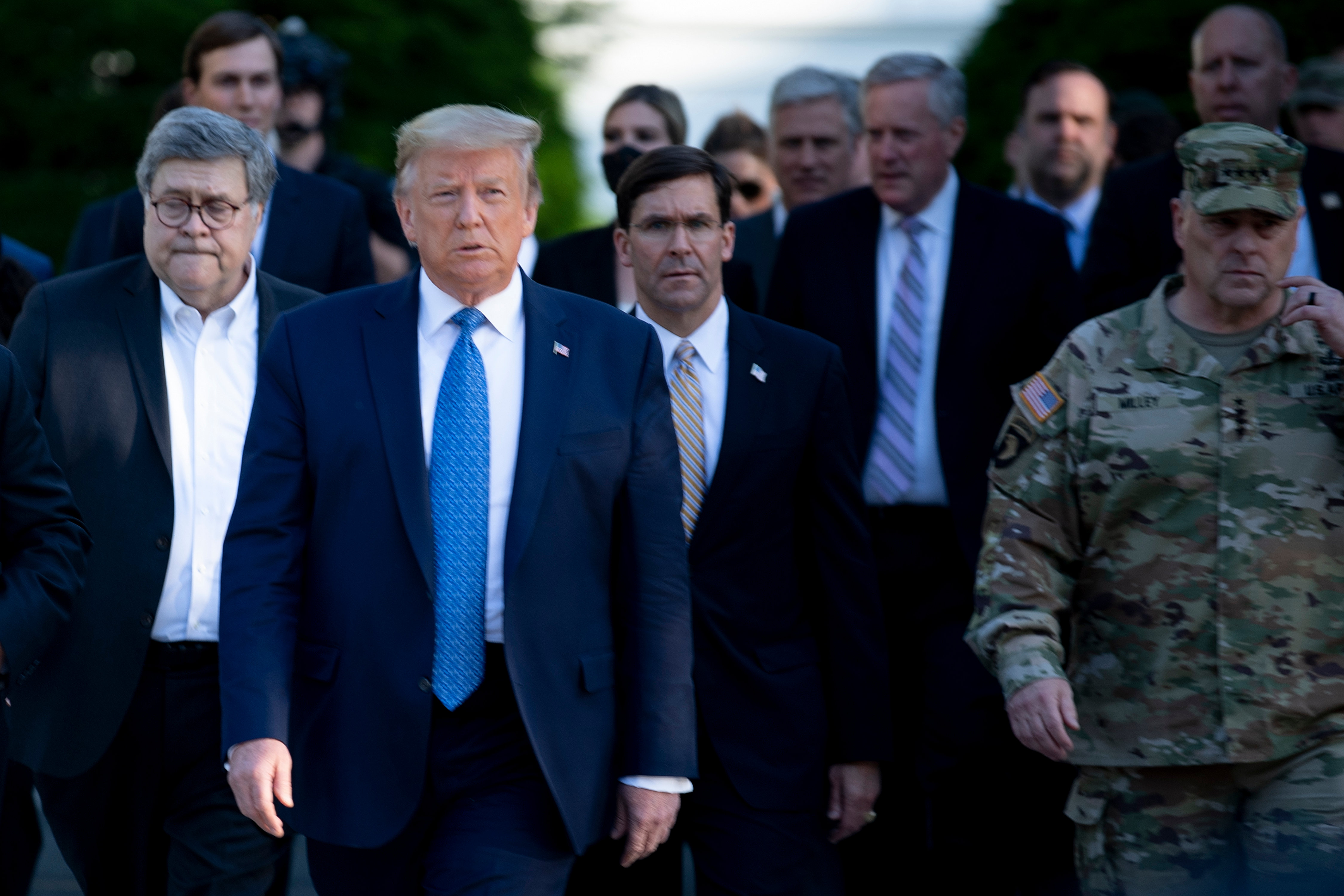 US President Donald Trump walks with US Attorney General William Barr (L), US Secretary of Defense Mark T. Esper (C), Chairman of the Joint Chiefs of Staff Mark A. Milley (R), and others from the White House to visit St. John's Church after the area was cleared of people protesting the death of George Floyd June 1, 2020, in Washington, DC. - US President Donald Trump was due to make a televised address to the nation on Monday after days of anti-racism protests against police brutality that have erupted into violence. The White House announced that the president would make remarks imminently after he has been criticized for not publicly addressing in the crisis in recent days. (Photo by BRENDAN SMIALOWSKI/AFP via Getty Images)