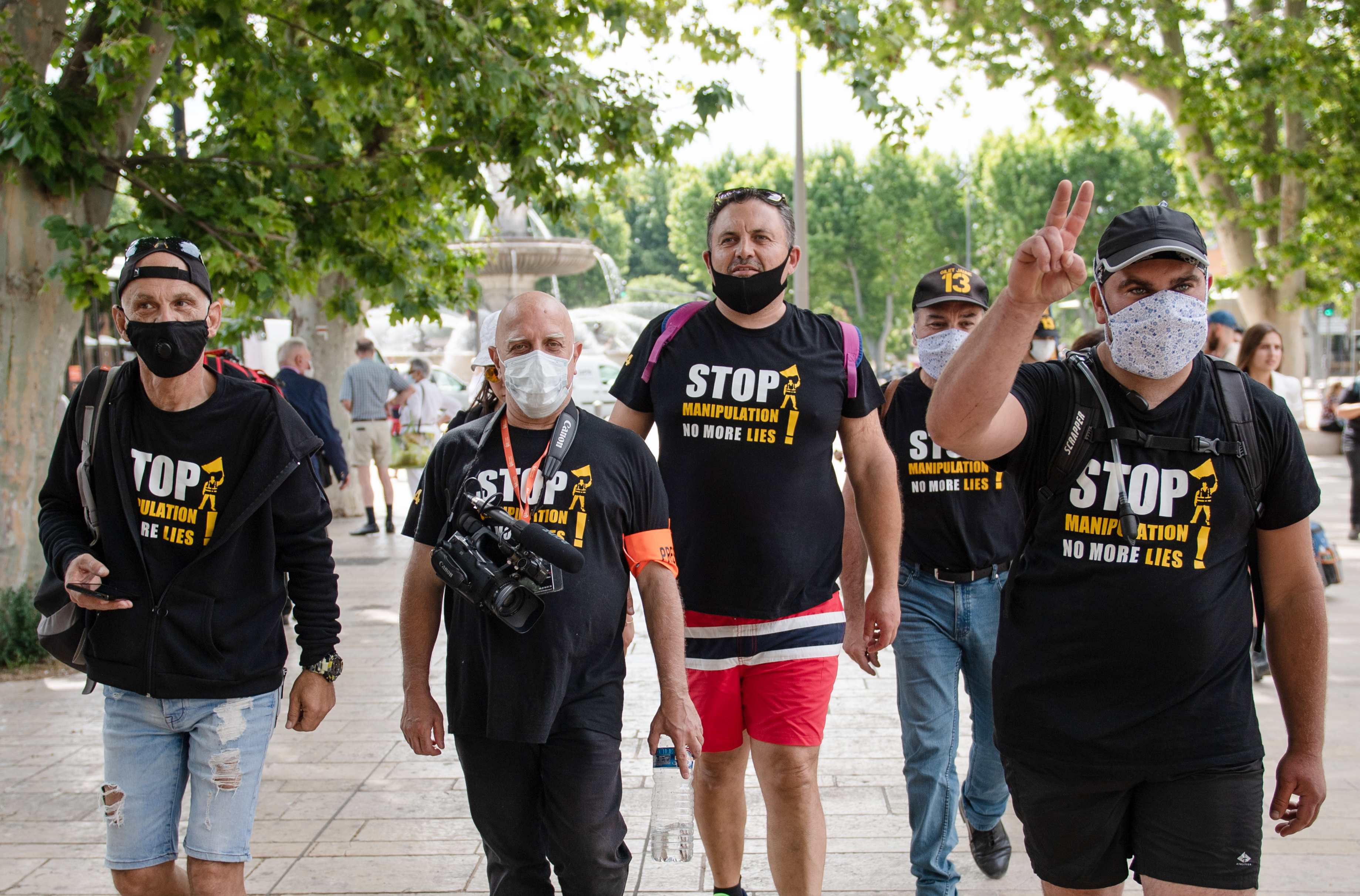 Yellow vests demonstrators wearing t-shirts reading "Stop Manipulation, no more lies" walks as they take part in the "Marseille to Paris " march from Aix-en-Provence to Paris, on June 2, 2020. (Photo by CLEMENT MAHOUDEAU/AFP via Getty Images)