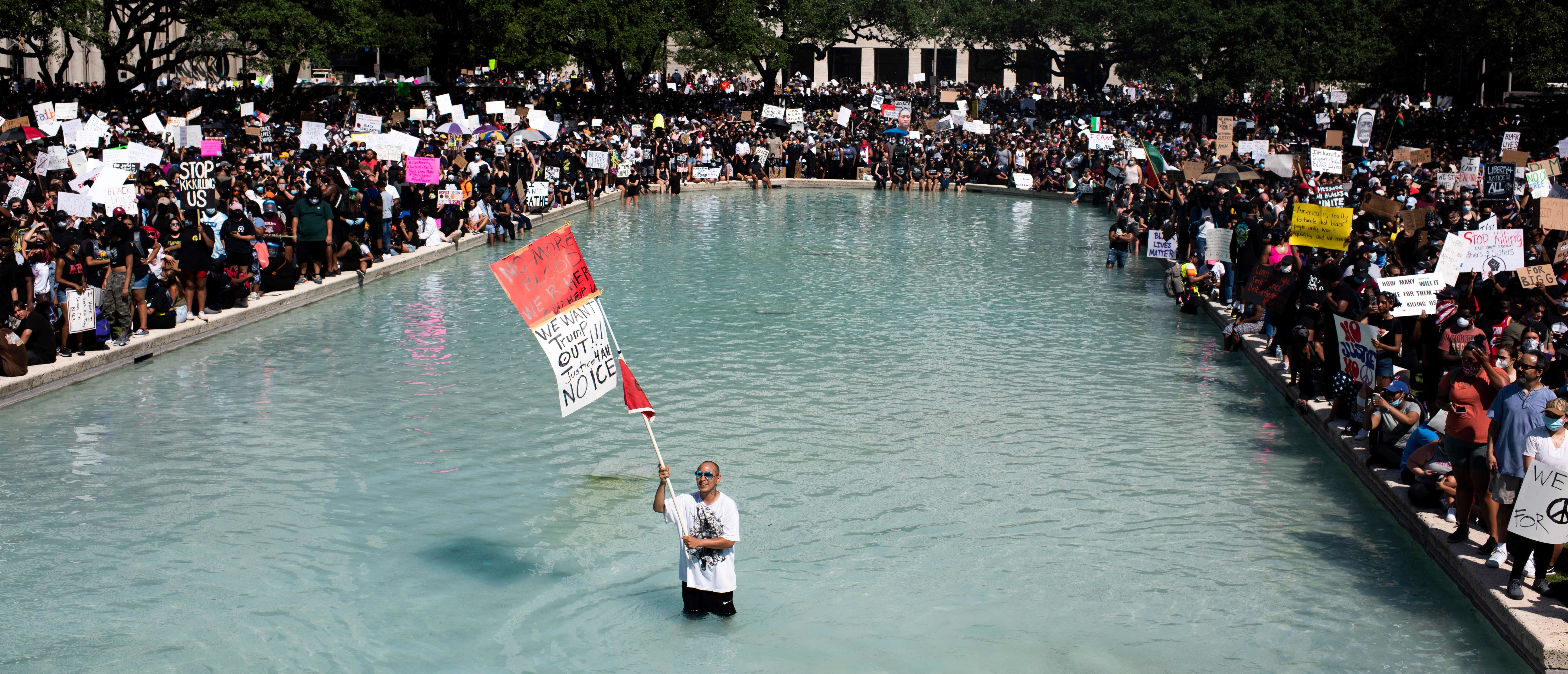 Protesters demonstrate to mourn the death of George Floyd during a march across downtown Houston, Texas, on June 2, 2020. - Anti-racism protests have put several US cities under curfew to suppress rioting, following the death of George Floyd while in police custody. (Photo by Mark Felix / AFP) (Photo by MARK FELIX/AFP via Getty Images)