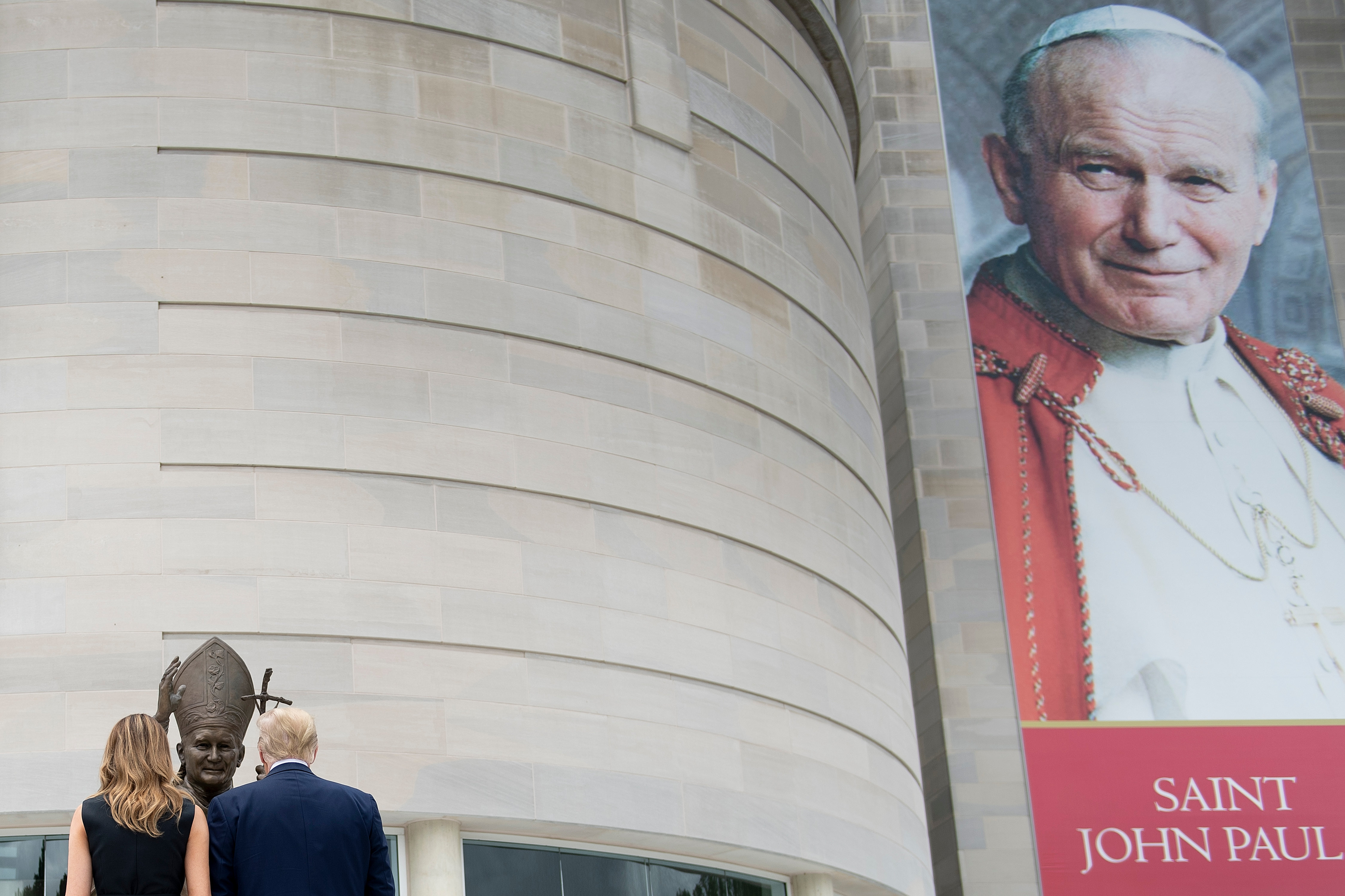 US President Donald Trump and First Lady Melania Trump visit the Saint John Paul II National Shrine, to lay a ceremonial wreath and observe a moment of remembrance under the Statue of Saint John Paul II on June 2, 2020 in Washington,DC. (Photo by BRENDAN SMIALOWSKI/AFP via Getty Images)