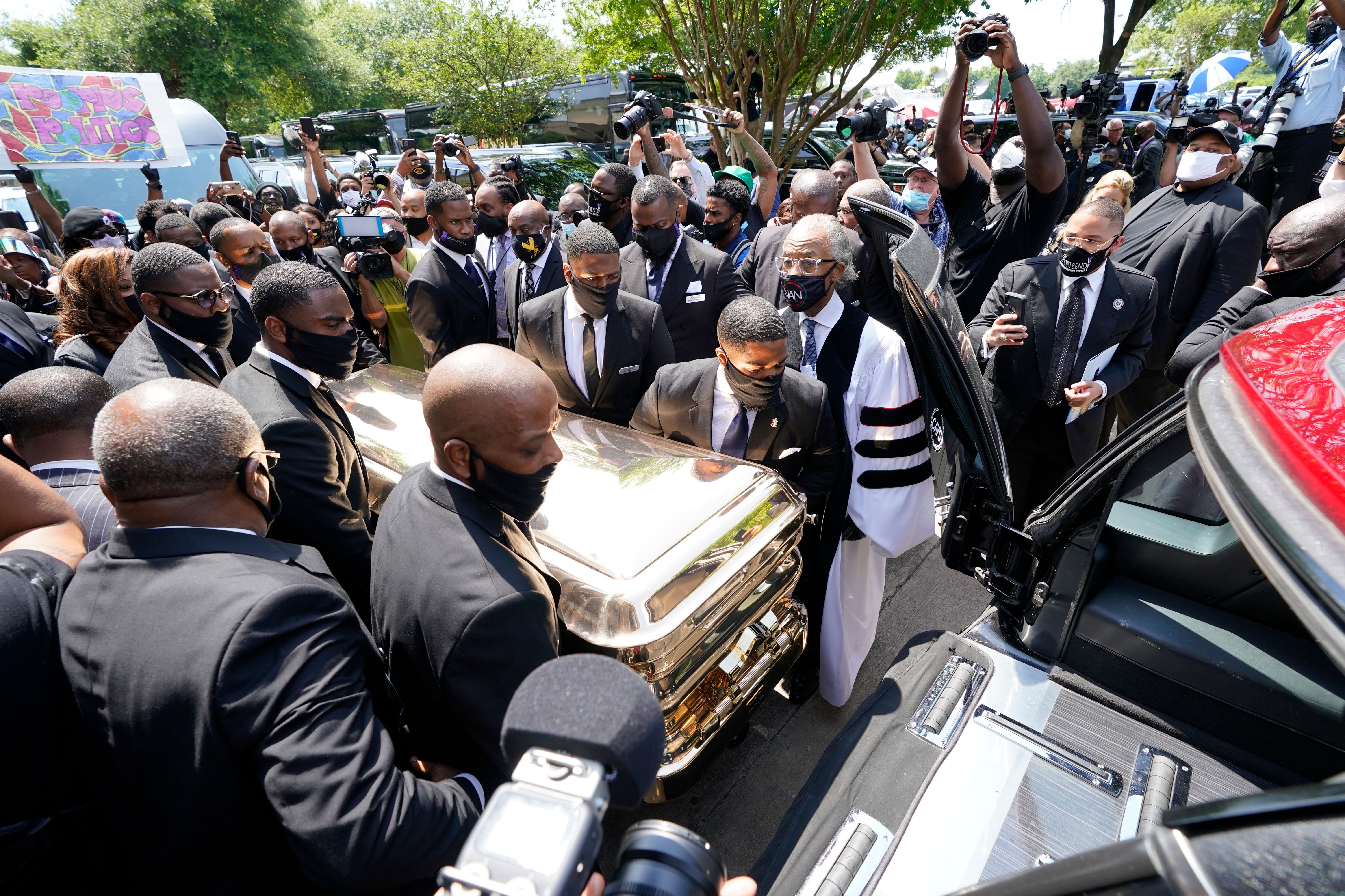 Pallbearers move the casket of George Floyd into a hearse as the Rev. Al Sharpton (C) looks on following Floyd's funeral June 9, 2020, at The Fountain of Praise church in Houston. (DAVID J. PHILLIP/POOL/AFP via Getty Images)