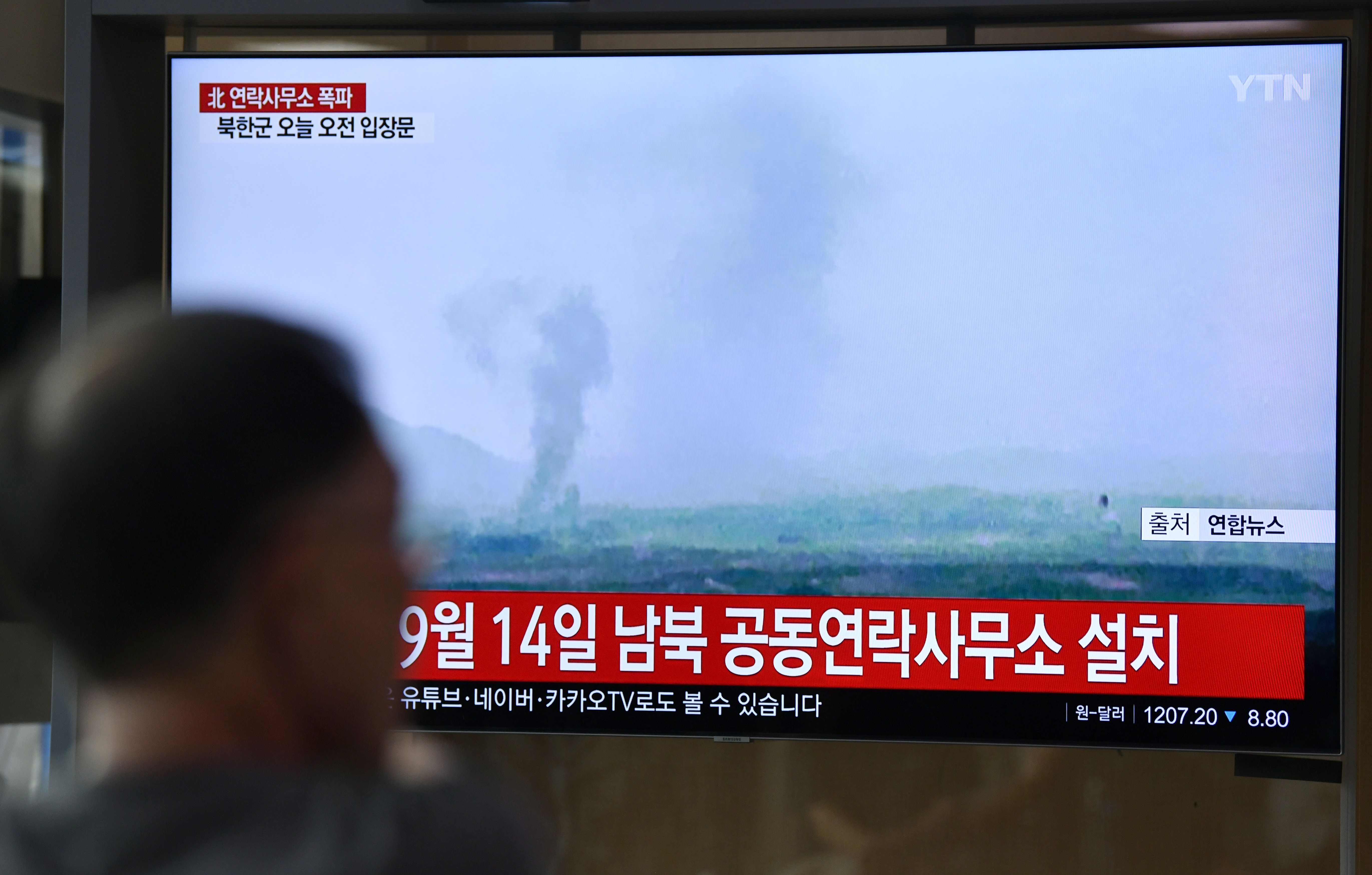 People watch a television news screen showing an explosion of an inter-Korean liaison office in North Korea's Kaesong Industrial Complex, at a railway station in Seoul on June 16, 2020. (Photo by JUNG YEON-JE/AFP via Getty Images)