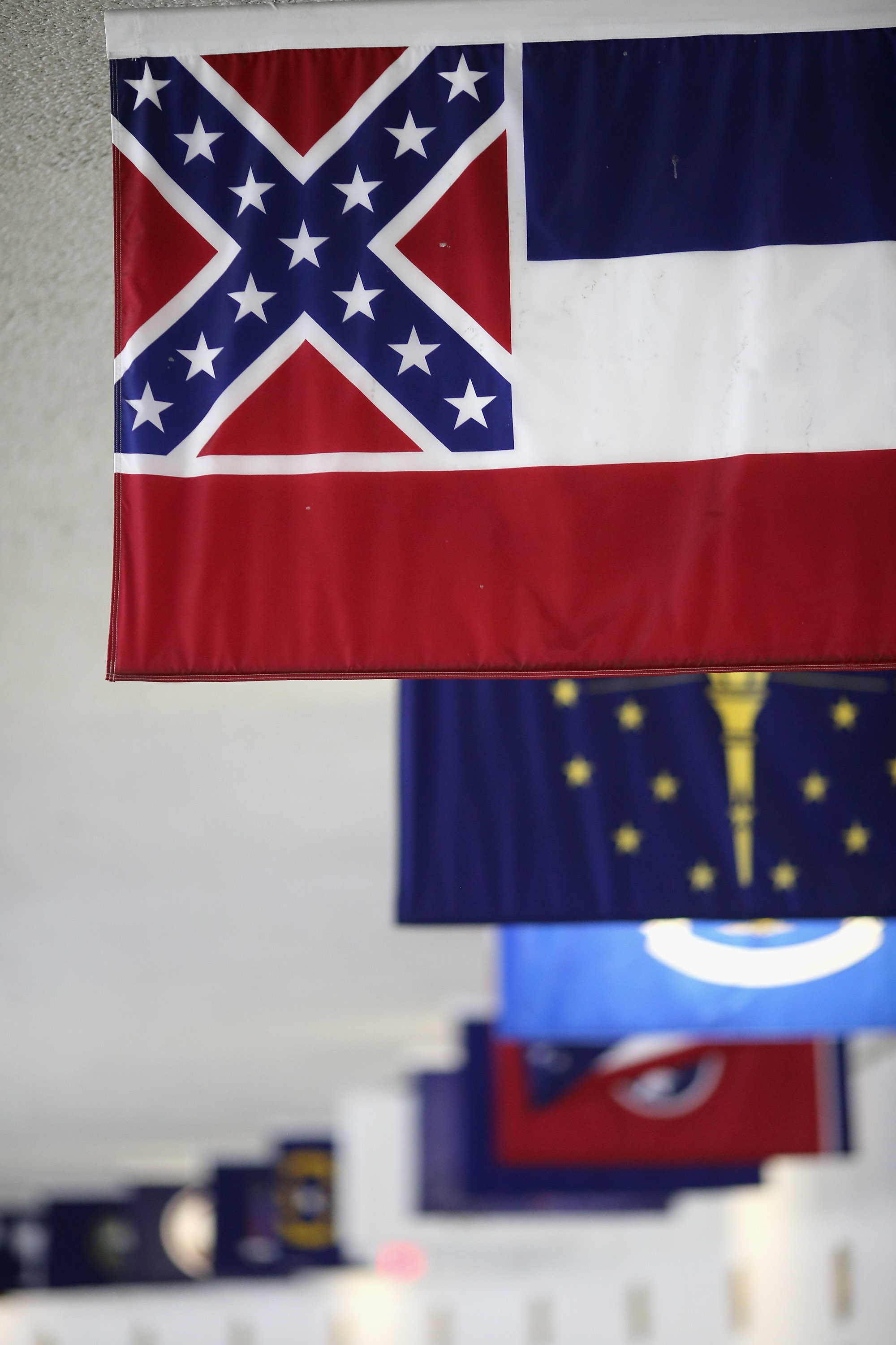 The state flag of Mississippi, which incorporates the flag of the Confederate States of America in the top left corner, is displayed with the flags of the other 49 states and territories in the tunnel connecting the senate office building and the U.S. Capitol June 23, 2015 in Washington, DC. (Photo by Chip Somodevilla/Getty Images)