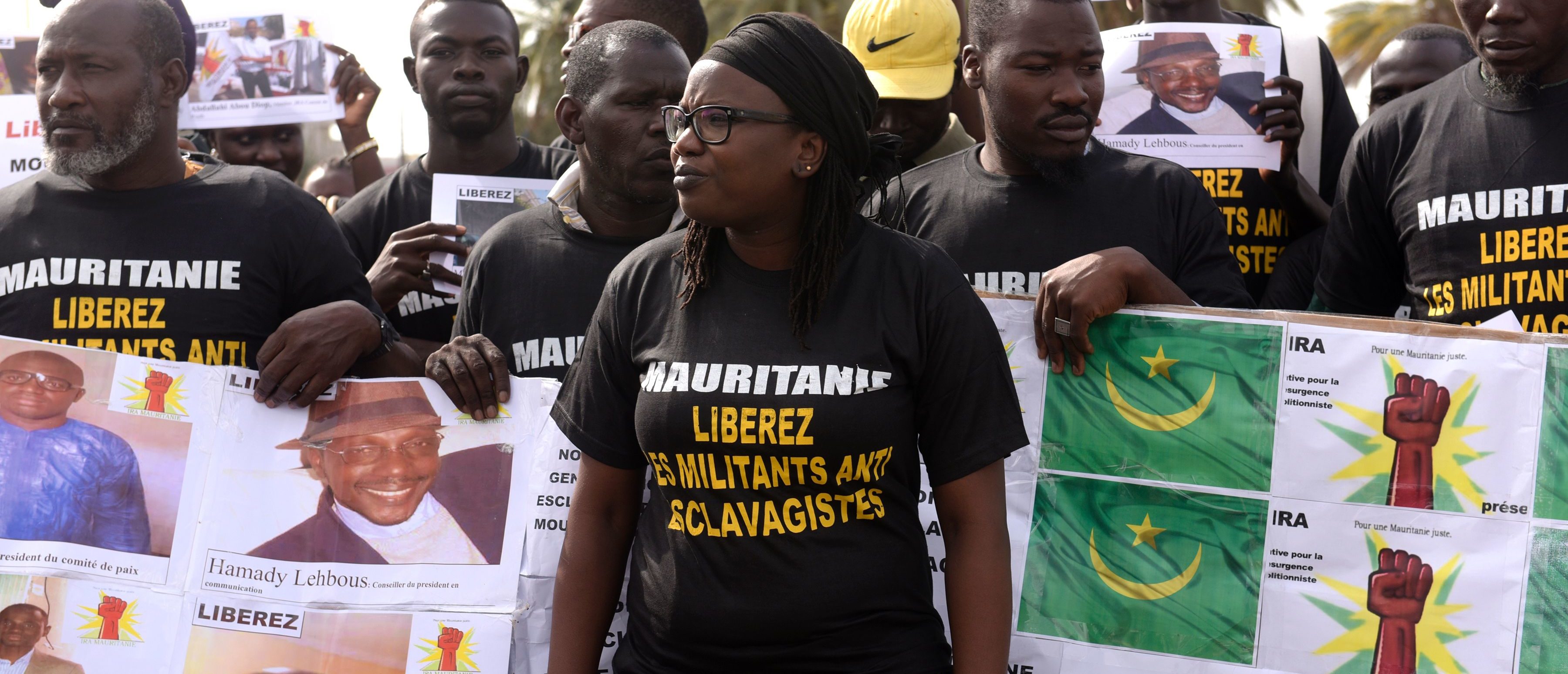 Anti slavery militants hold a banner which translates as "No to slavery and racism, no to the regime of the general dictator slavery racist Mouhamed Abdel Aziz" demonstrate on August 3, 2016 in Dakar against the imprisonement of fellow activists in Mauritania. / AFP / SEYLLOU (Photo credit should read SEYLLOU/AFP via Getty Images)