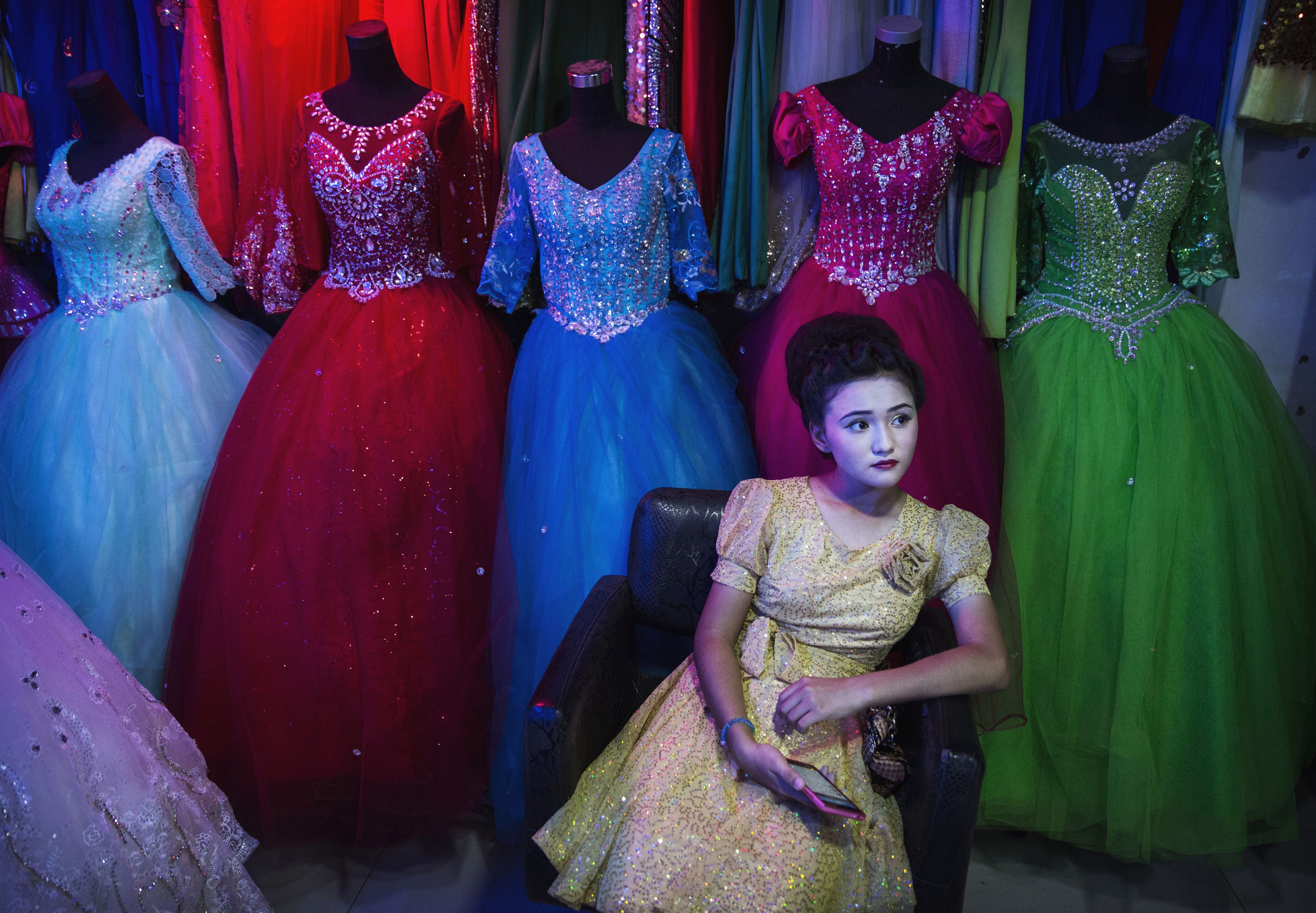 An ethnic Uyghur girl waits in a beauty salon to have her hair done before the Corban festival on September 8, 2016 in Turpan County, in the far western Xinjiang province, China. (Photo by Kevin Frayer/Getty Images)