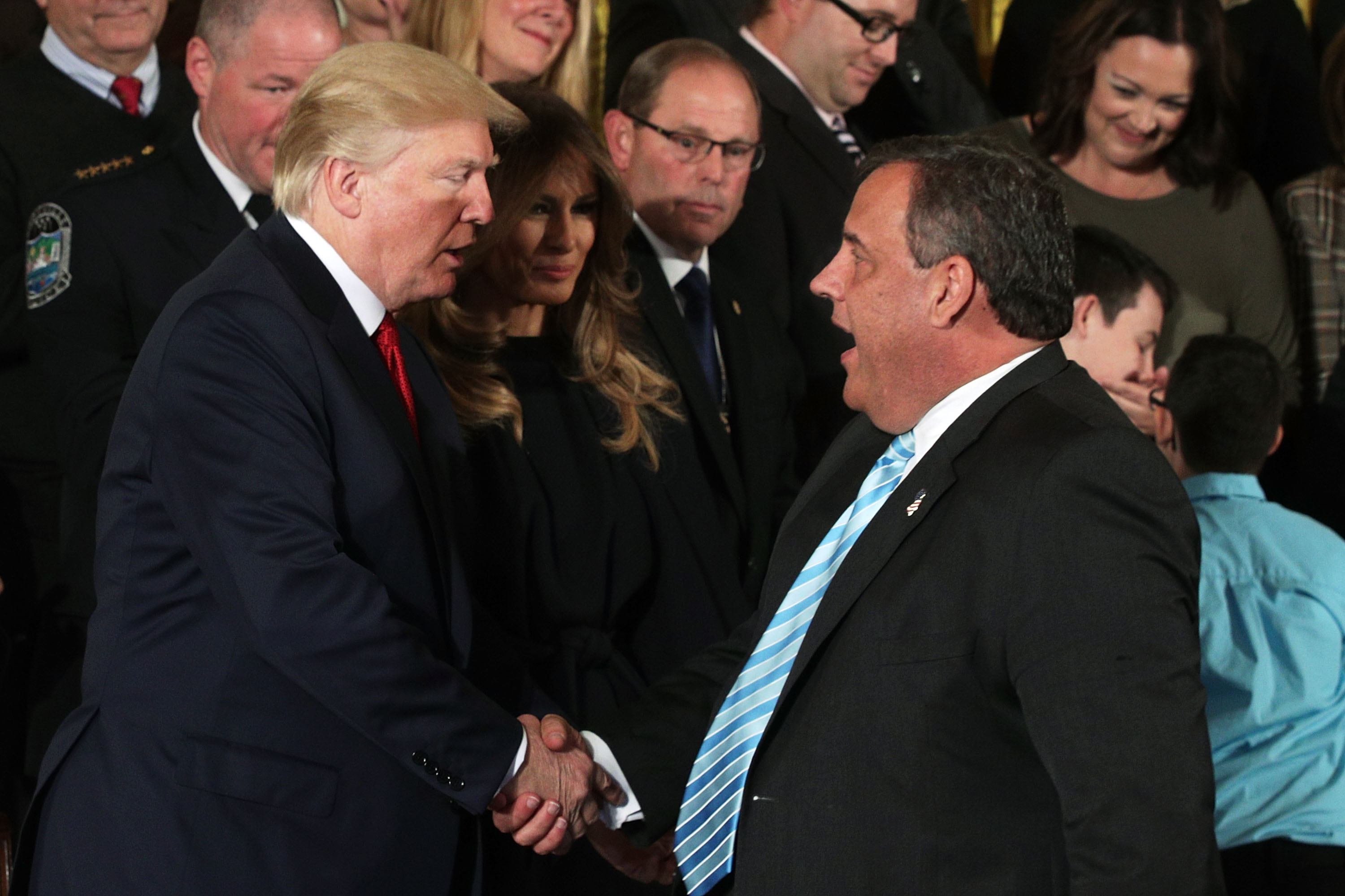 President Donald Trump shakes hands with New Jersey Governor Chris Christie as first lady Melania Trump looks on during an event highlighting the opioid crisis in the U.S. on October 26, 2017. (Photo: Alex Wong/Getty Images)