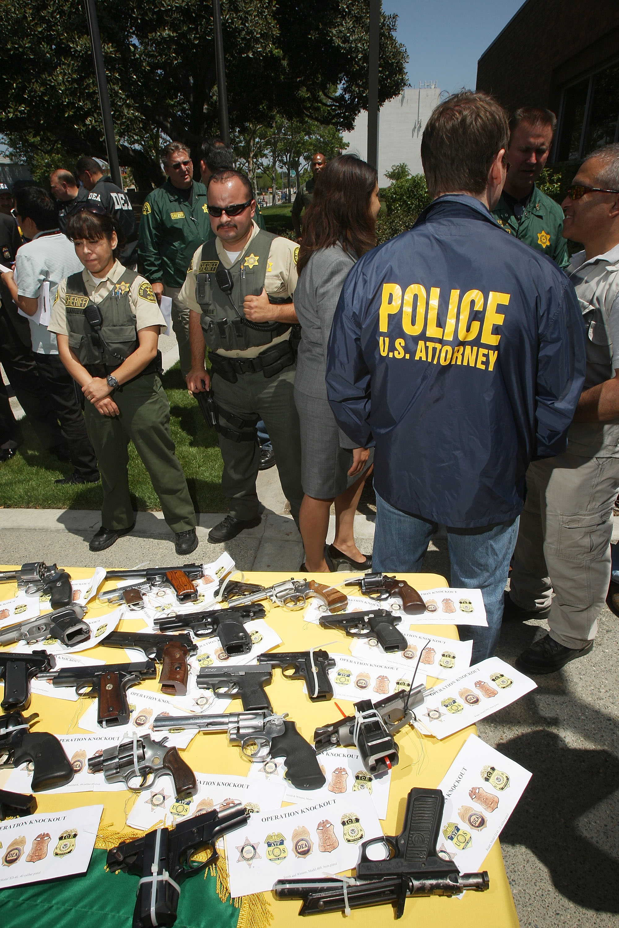 Some of about 125 weapons confiscated during what the federal authorities say is the largest gang takedown in United States history are displayed at a press conference to announce the arrests of scores of alleged gang members and associates on federal racketeering and drug-trafficking charges on May 21, 2009 in the Los Angeles-area community of Lakewood, California. (Photo by David McNew/Getty Images)