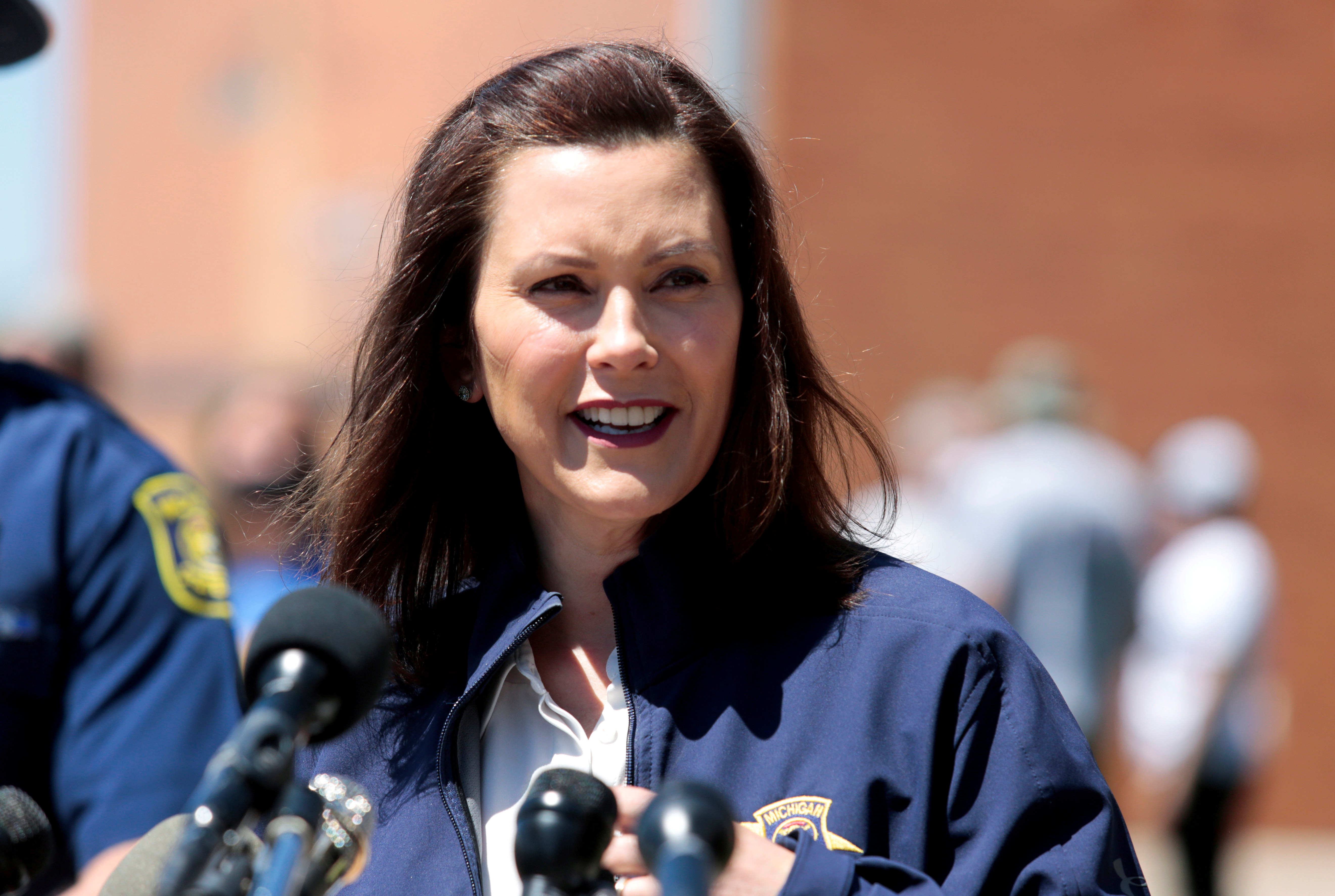 FILE PHOTO: Michigan Governor Gretchen Whitmer addresses the media about the flooding along the Tittabawassee River, after several dams breached, in downtown Midland, Michigan, U.S., May 20, 2020. REUTERS/Rebecca Cook